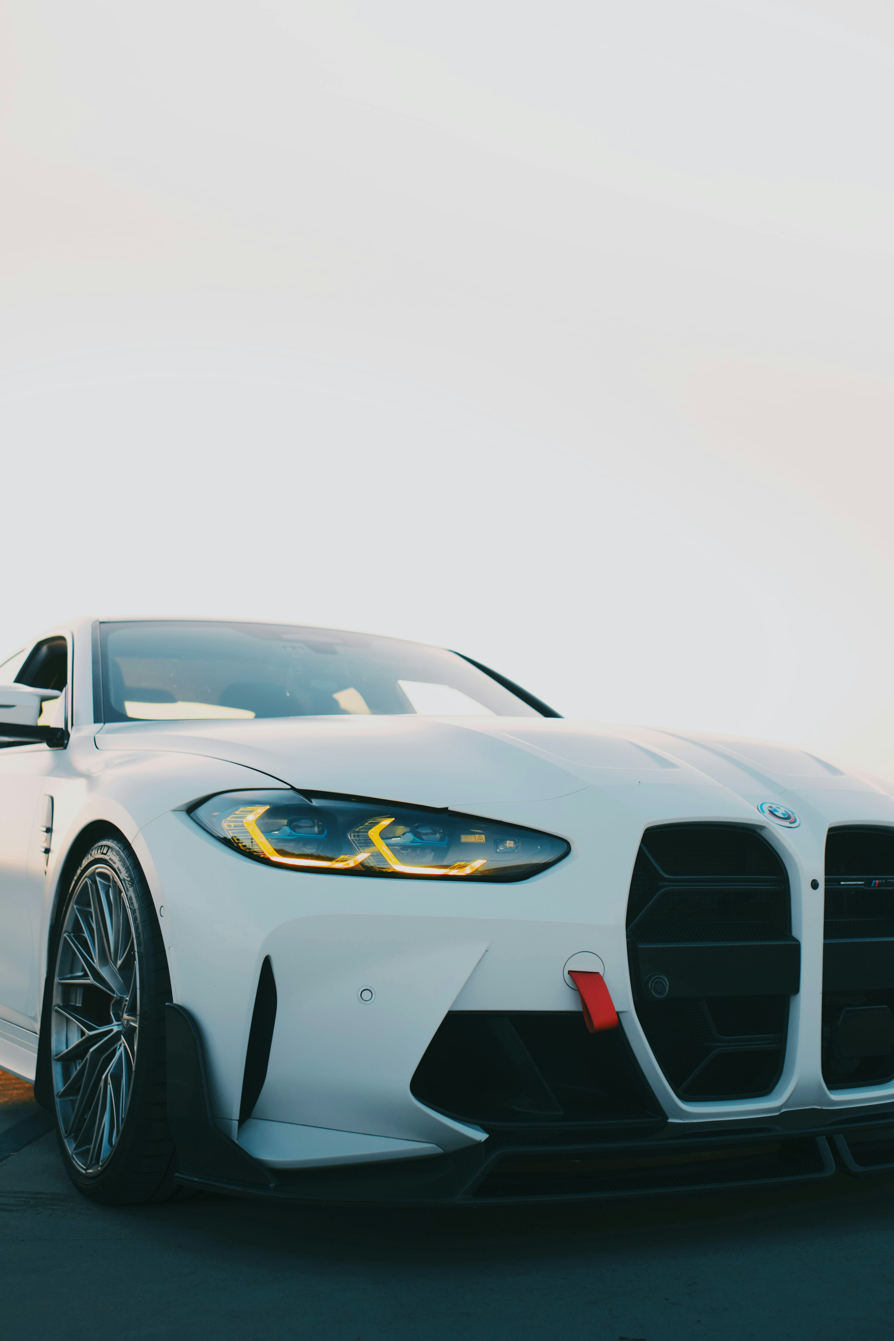 A white BMW m4 sports car is shown. photo