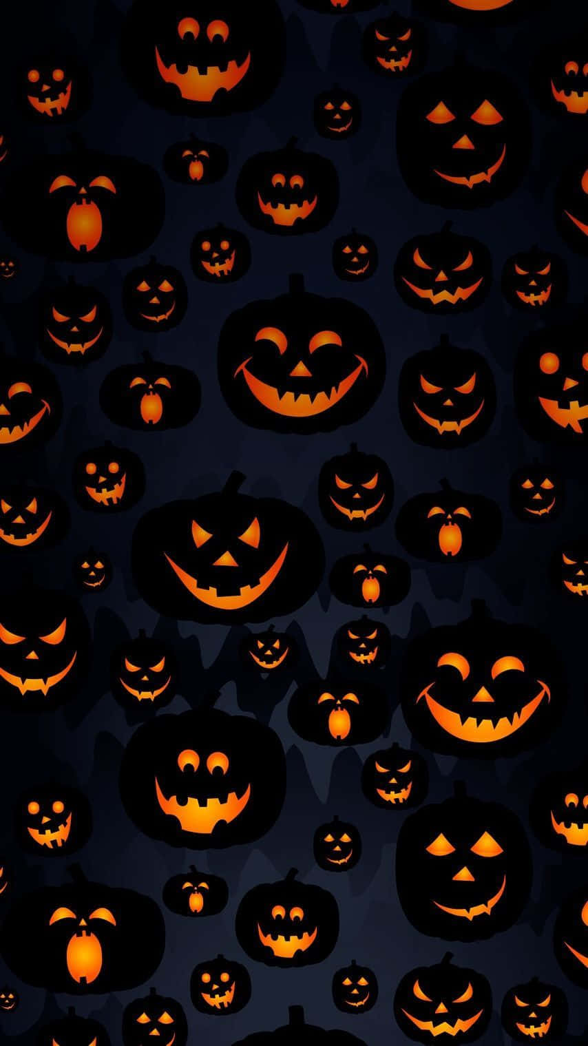 Download Halloween Pumpkins On A Dark Background Wallpaper
