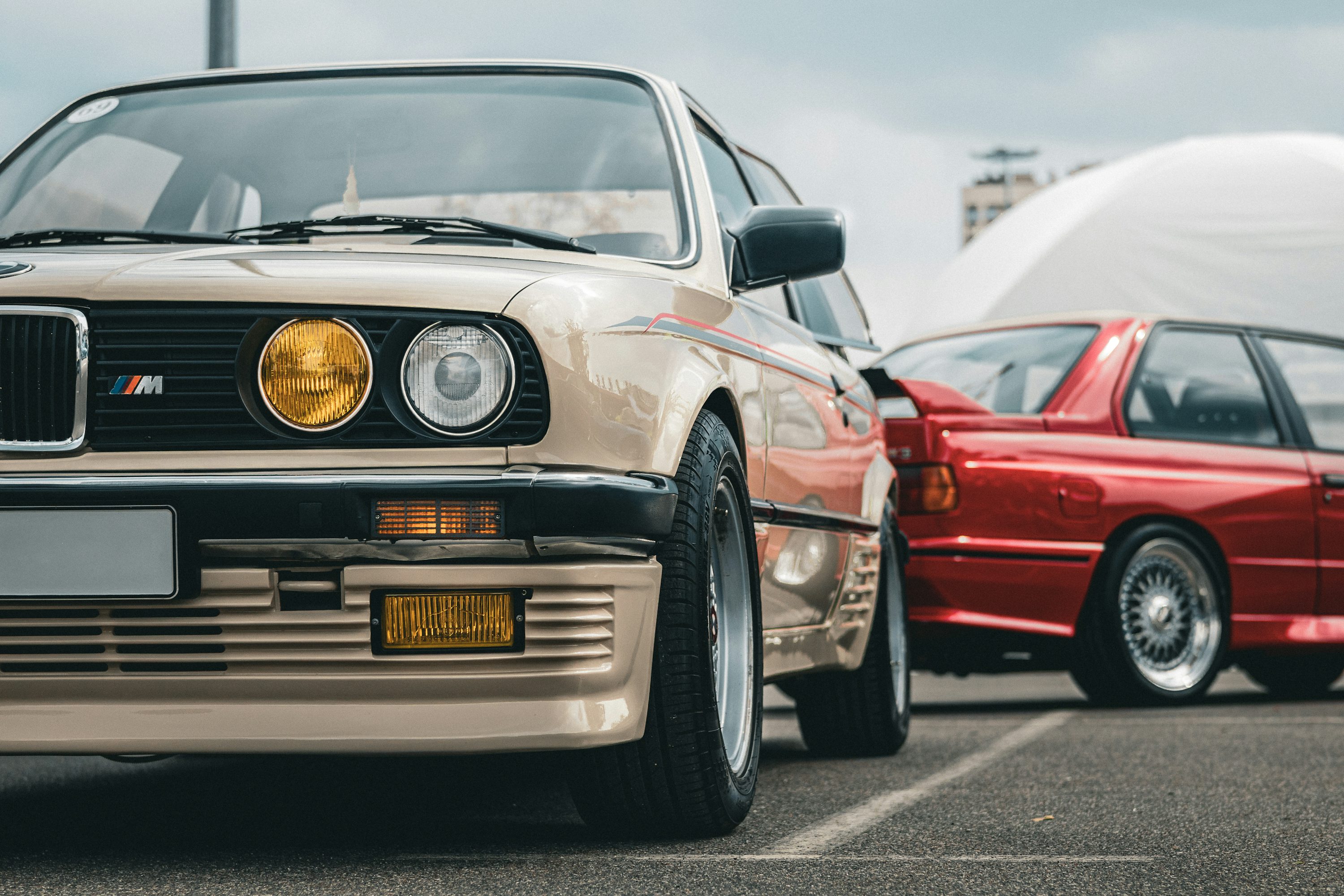 Classic BMW cars are parked outdoors. photo