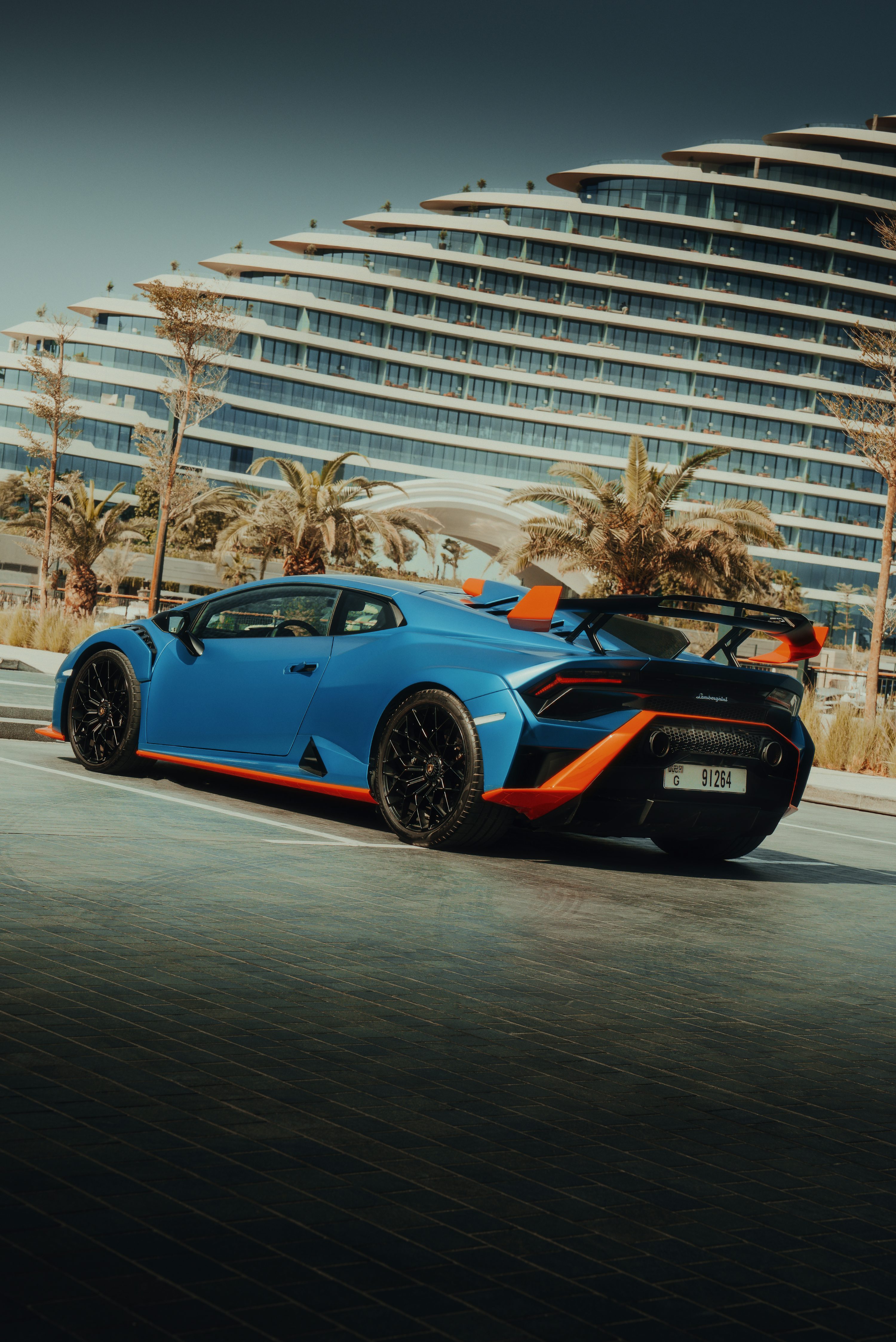 A blue lamborghini huracan parked near a building. photo