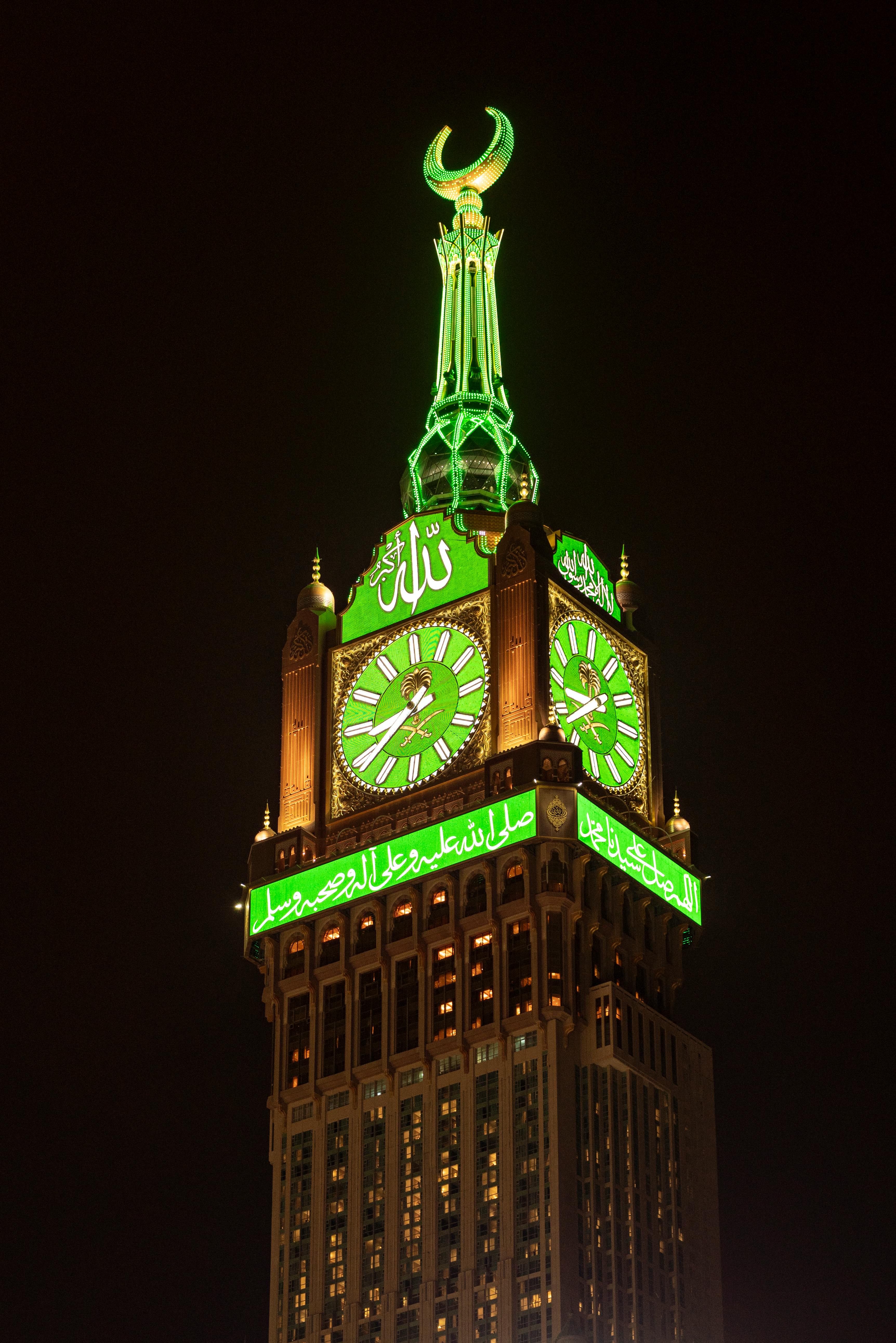 Photo of an Illuminating Makkah Royal Clock Tower at Night, Mecca, Saudi Arabia · Free