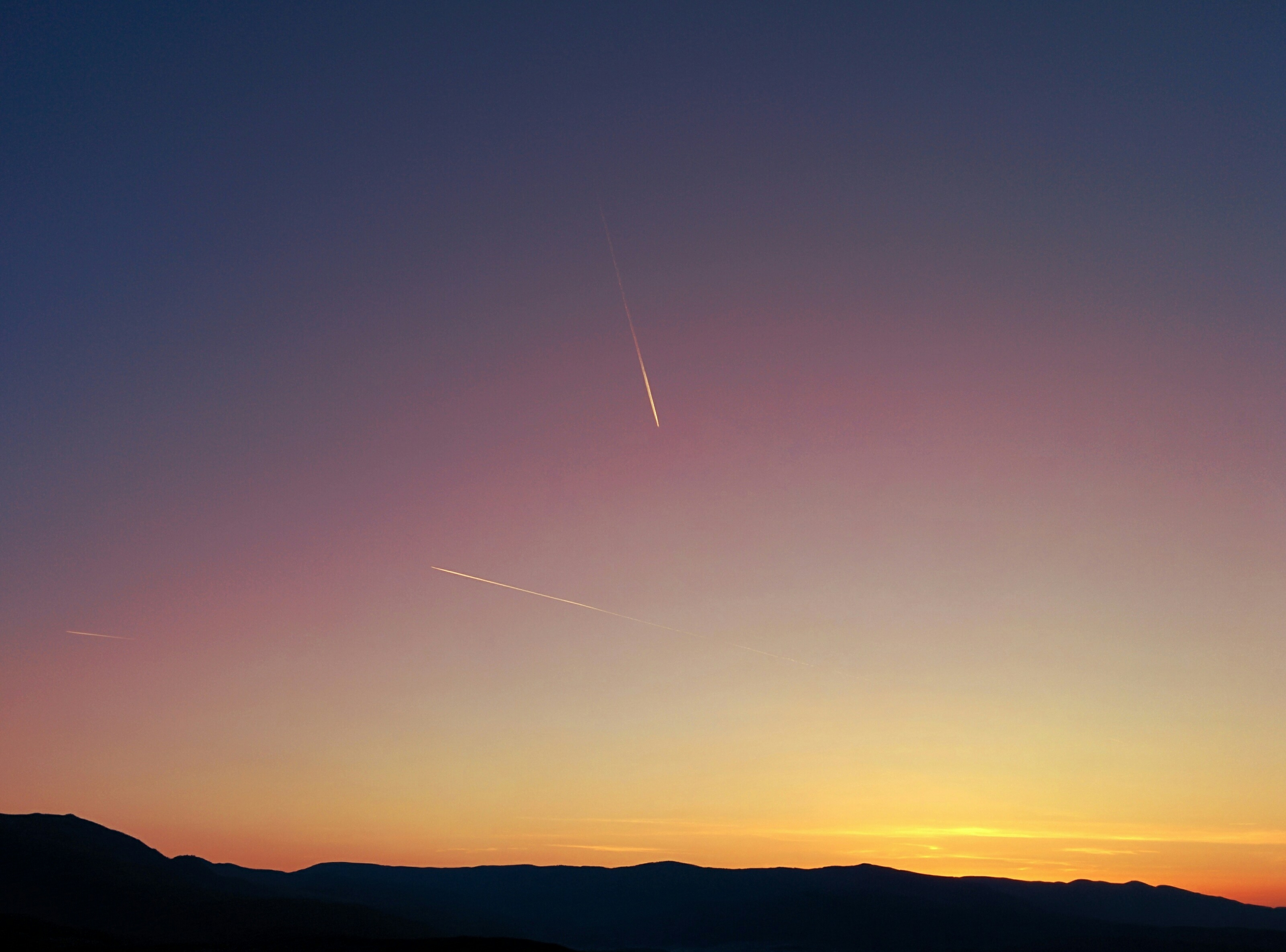 Plane Contrails Plane Trails In Orange Sunset Mountains Landscape