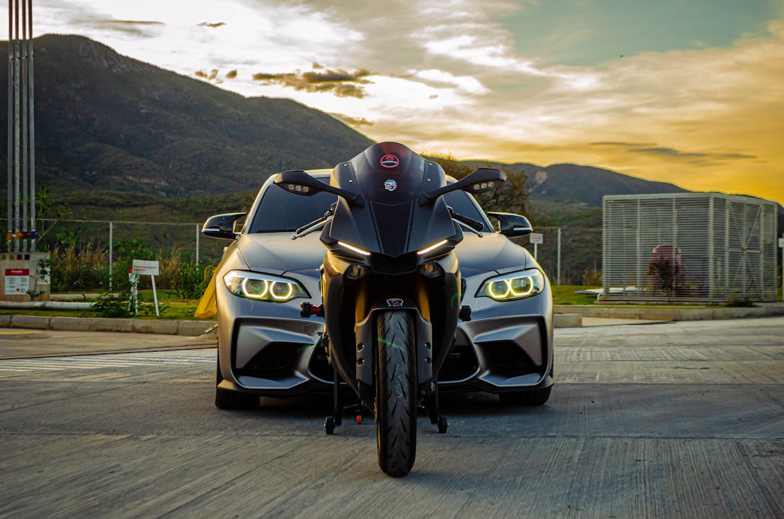 A Car and a Motorcycle at Sunset · Free