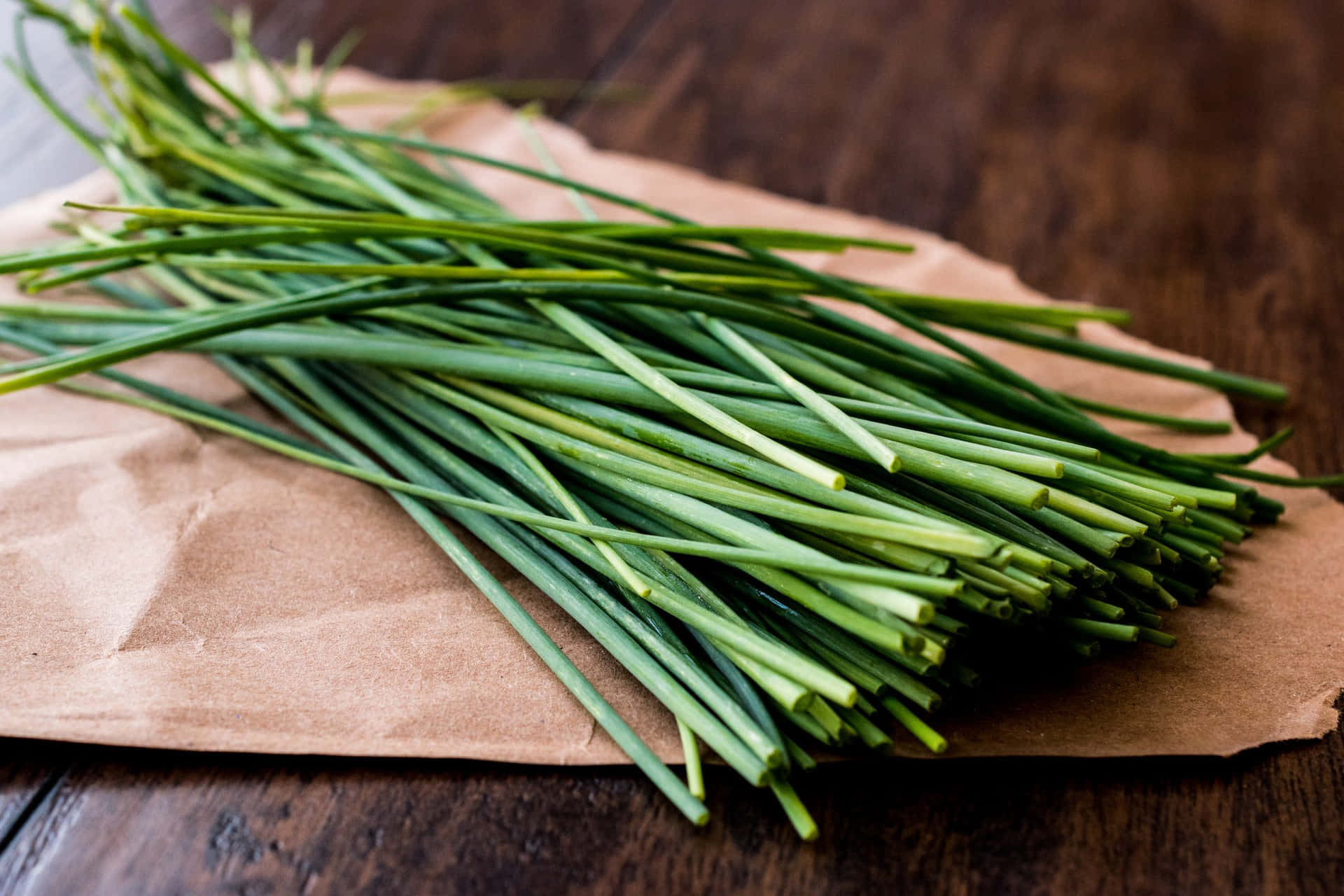 Download Fresh Green Chives On Brown Paper Wallpaper