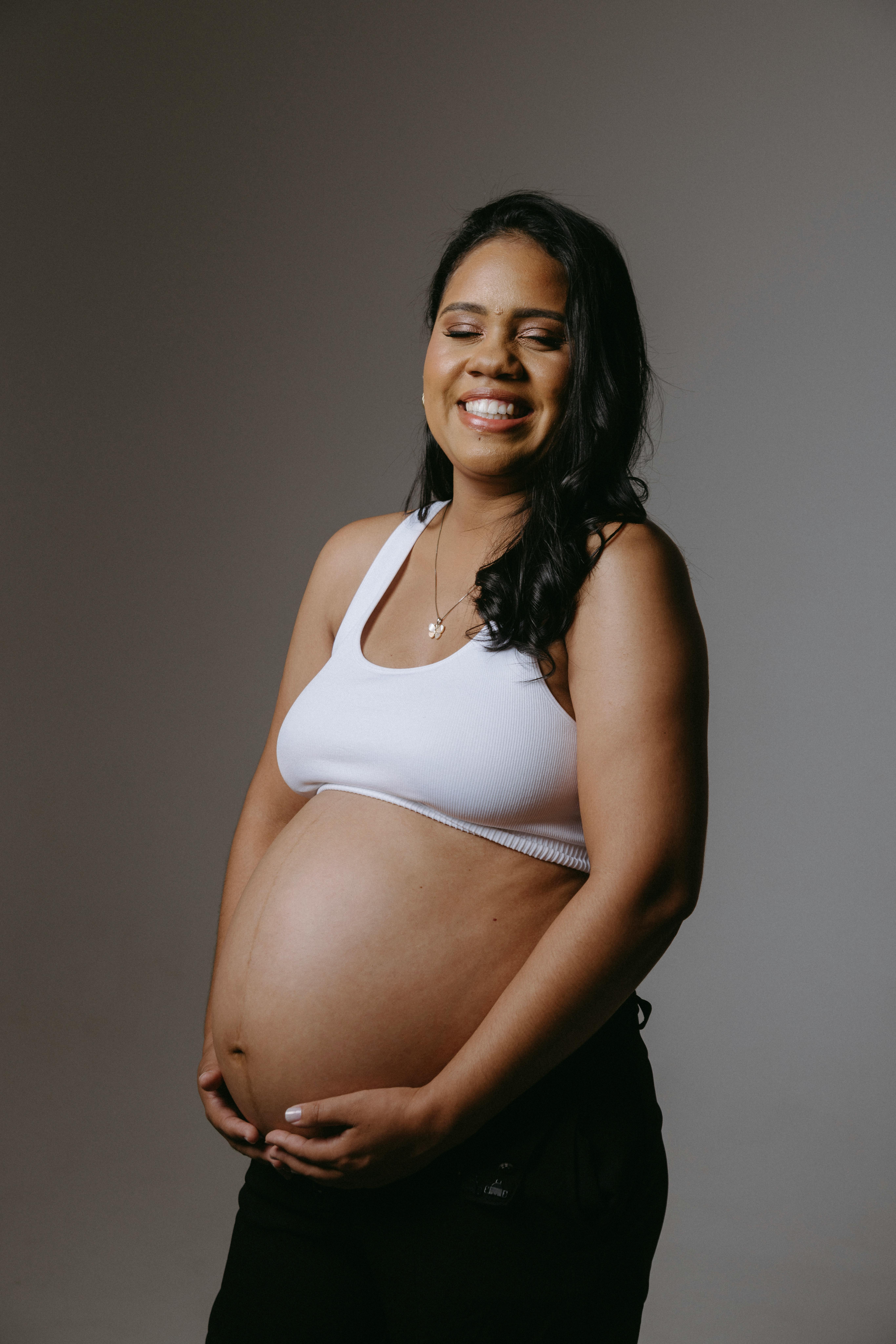 Pregnant Woman Posing in a Studio · Free