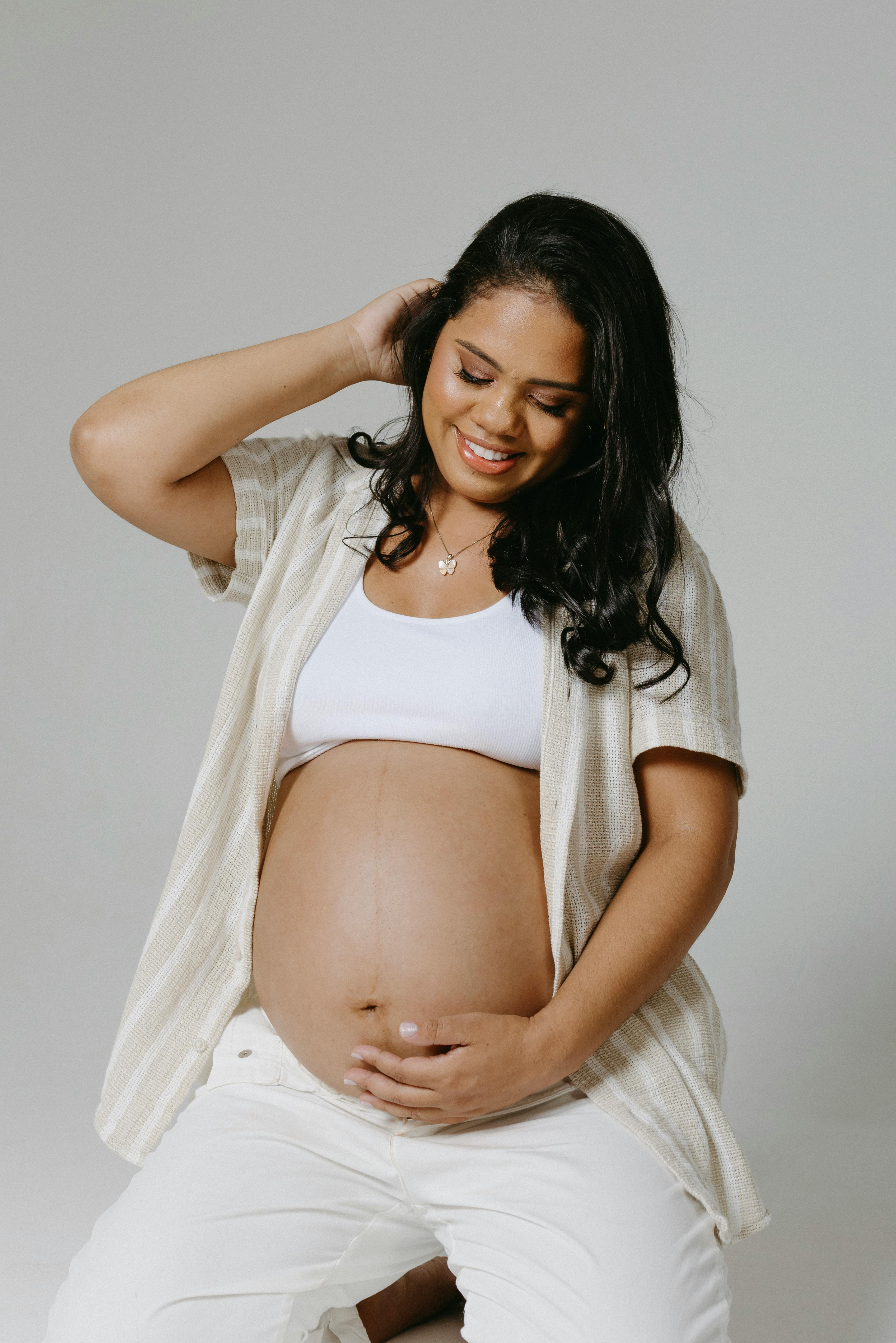 Pregnant Woman Posing in a Studio · Free