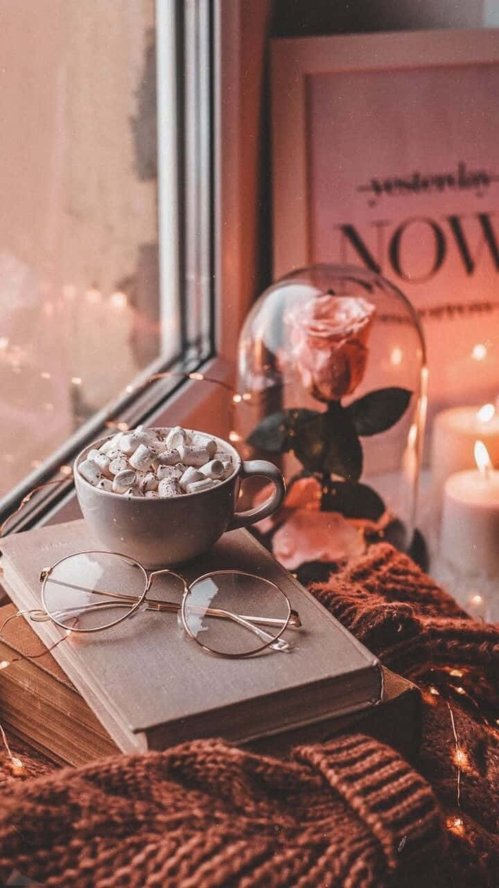 Download A Book, Coffee, And A Candle On A Window Sill