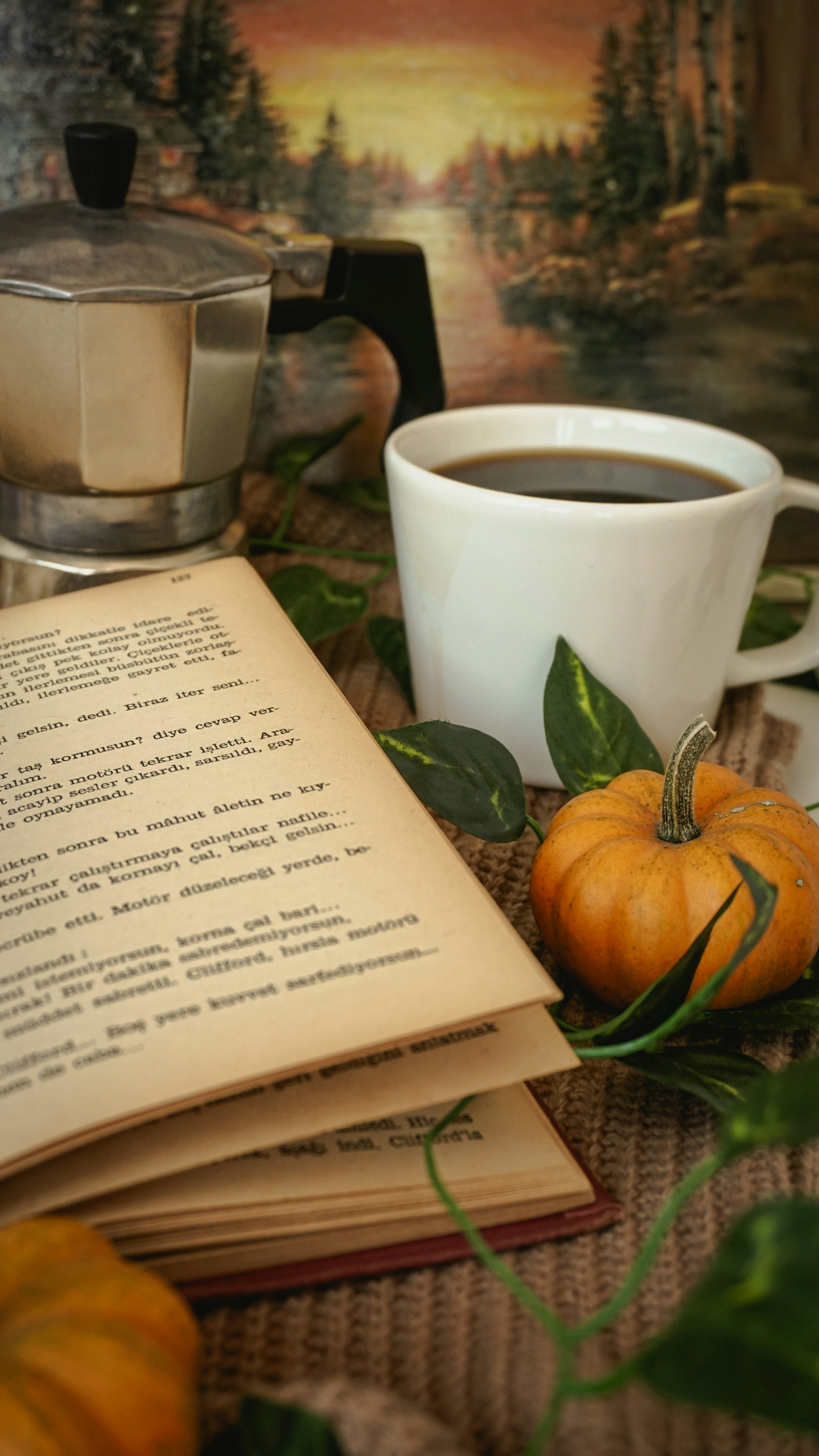 A cup of coffee and a book on a table photo