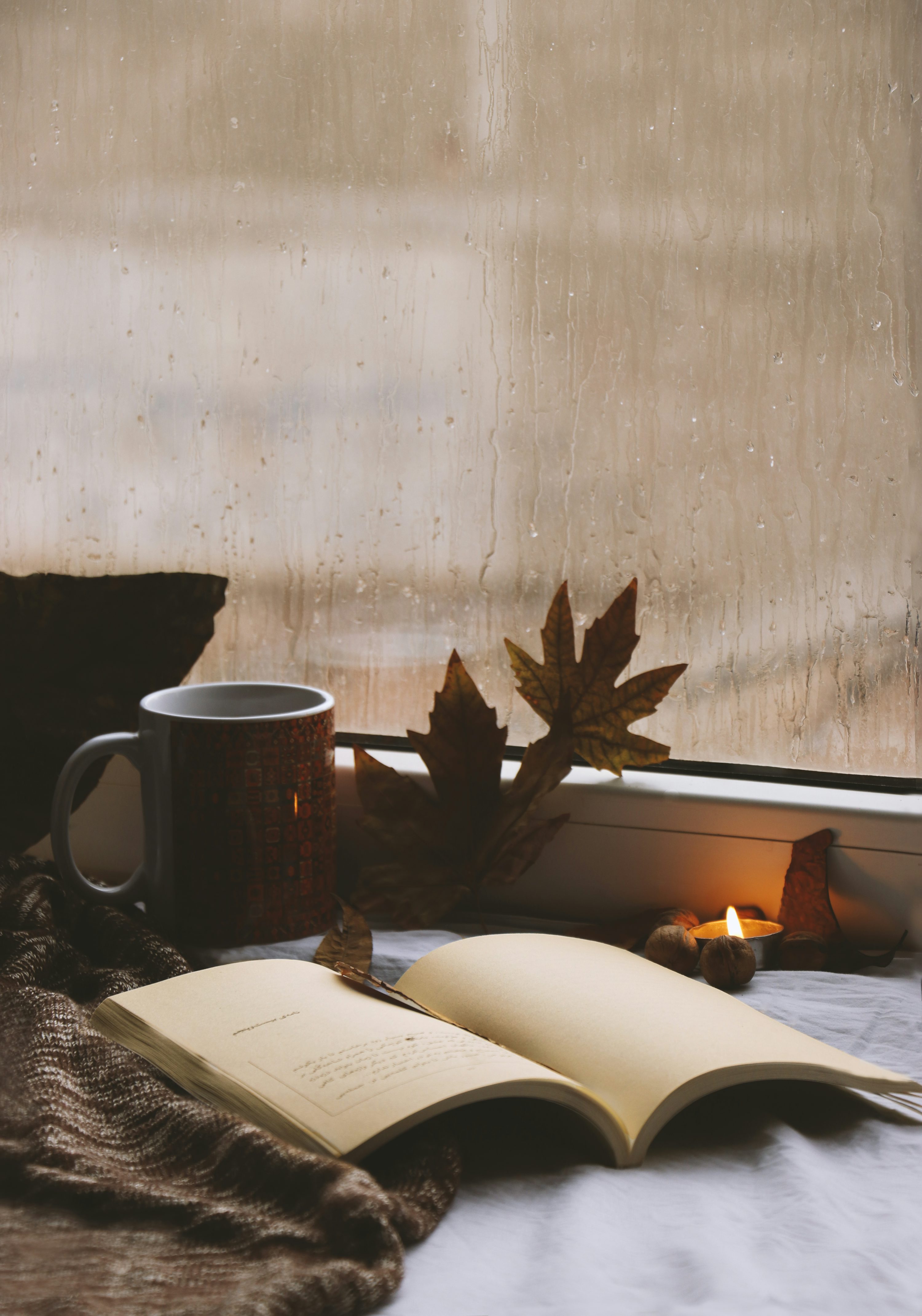 Autumnal still life with book, coffee, and candle. photo