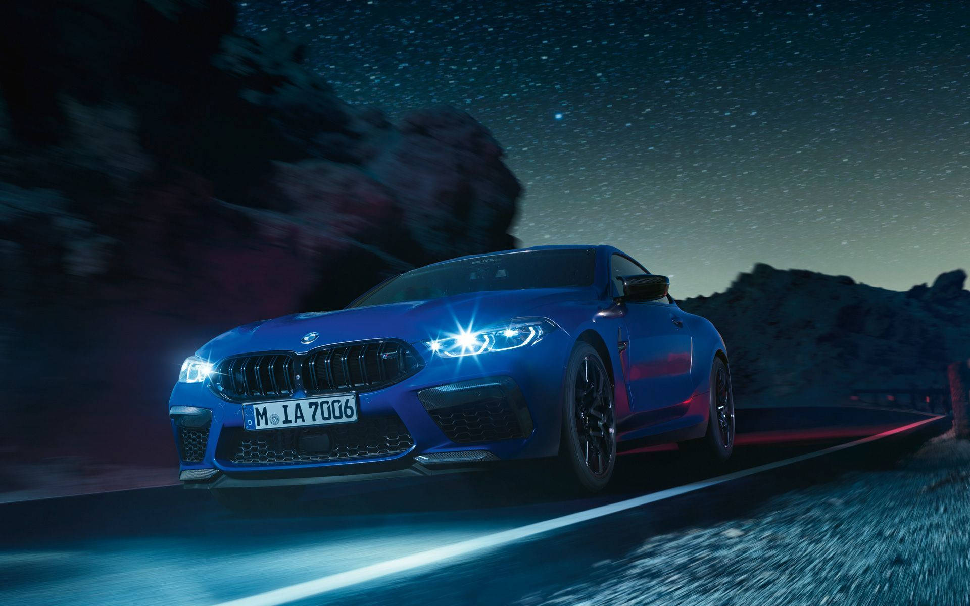 Download Blue BMW Driving At Night Wallpaper