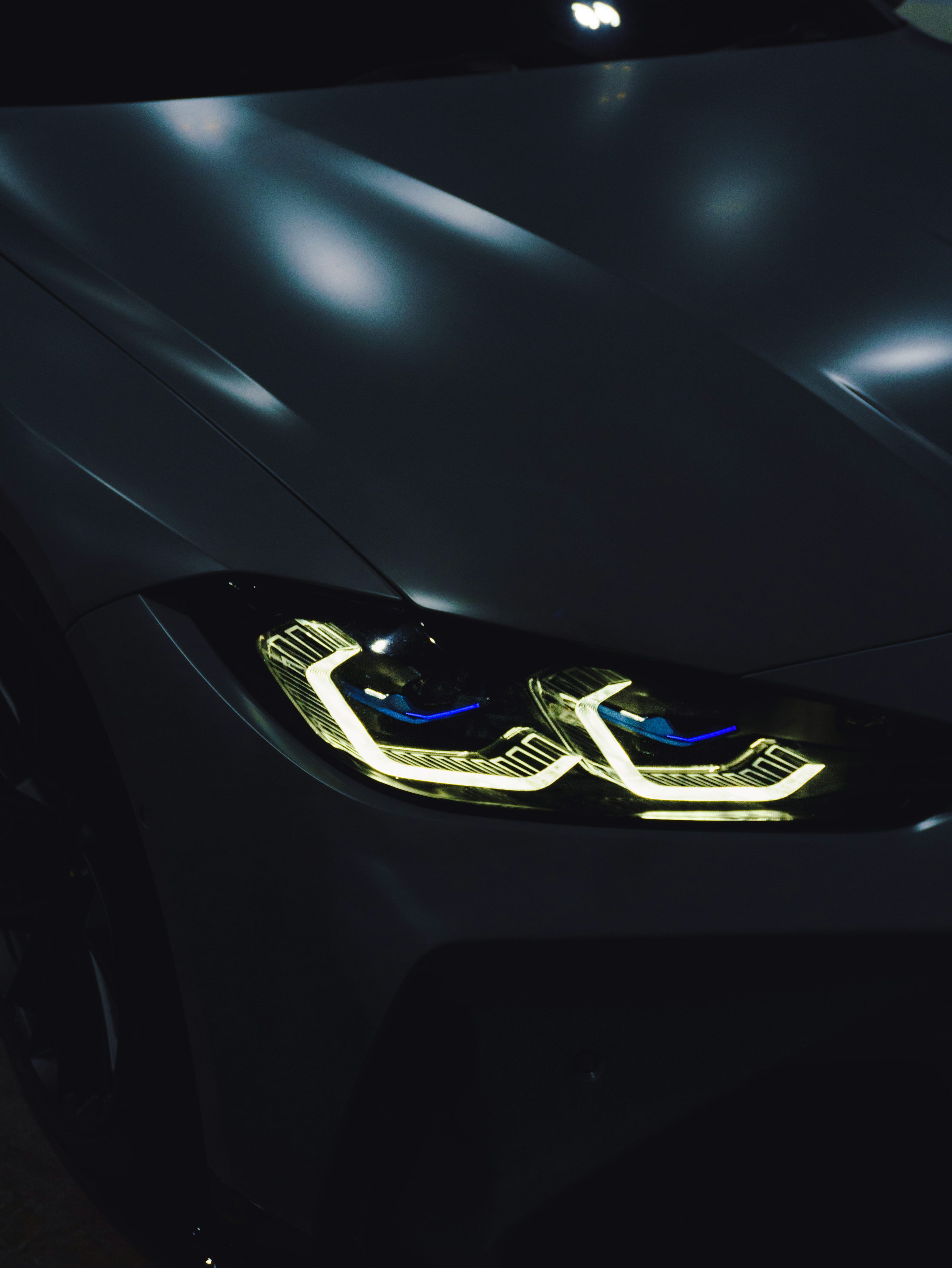 A close up of a car's headlights in the dark photo