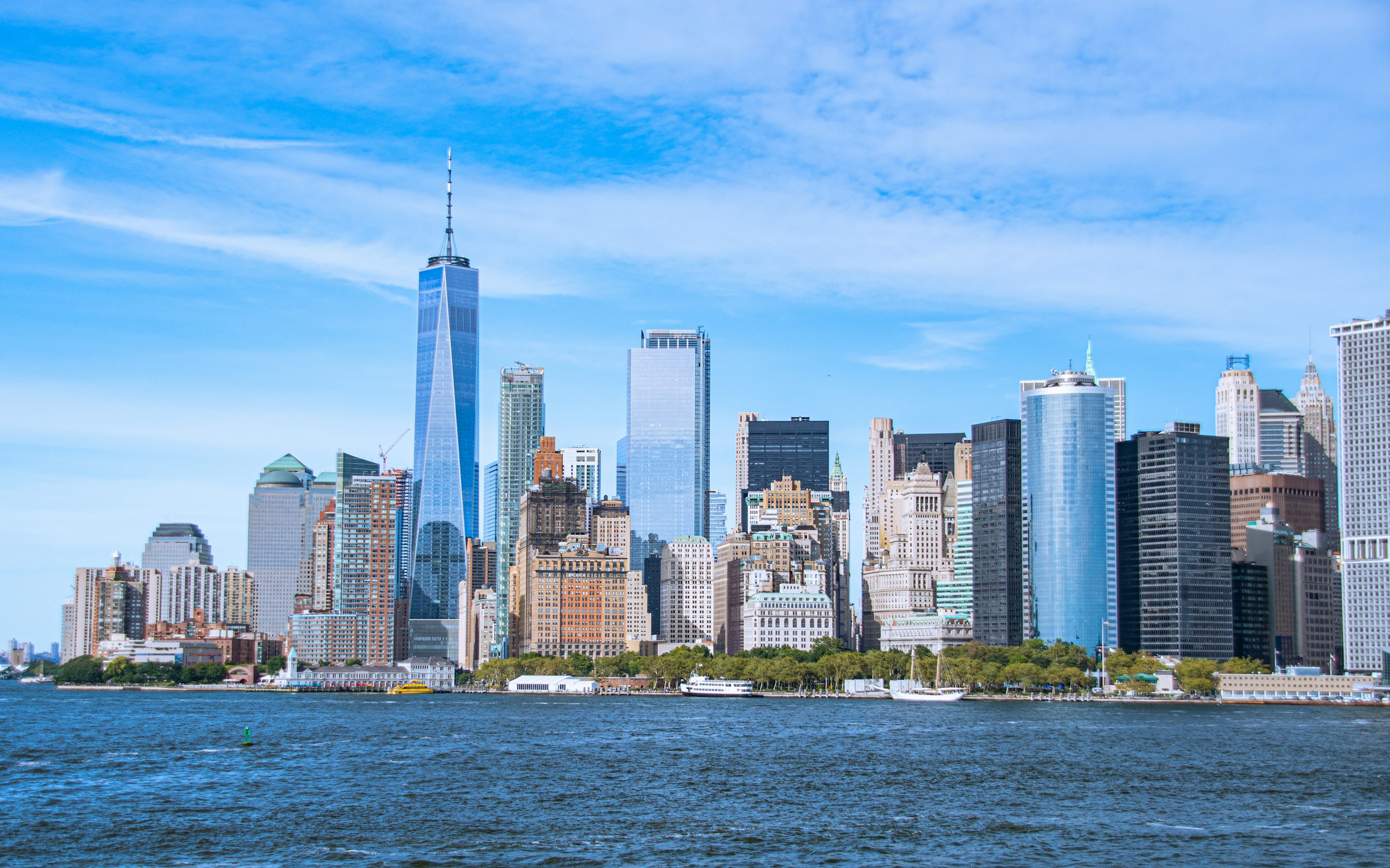 City skyline across body of water during daytime photo
