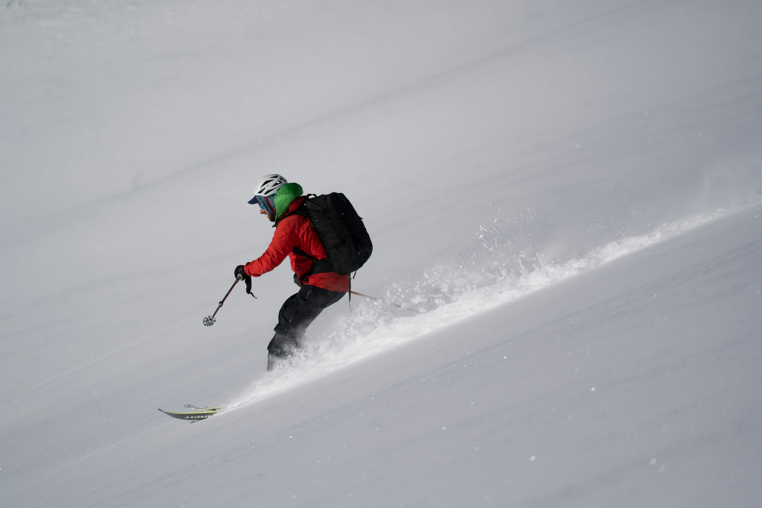 A skier going down a slope photo