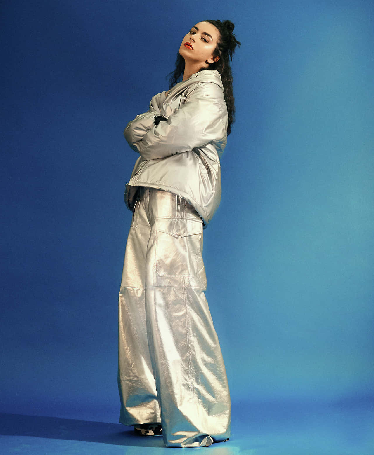 Download A Woman In A Silver Jacket And Pants