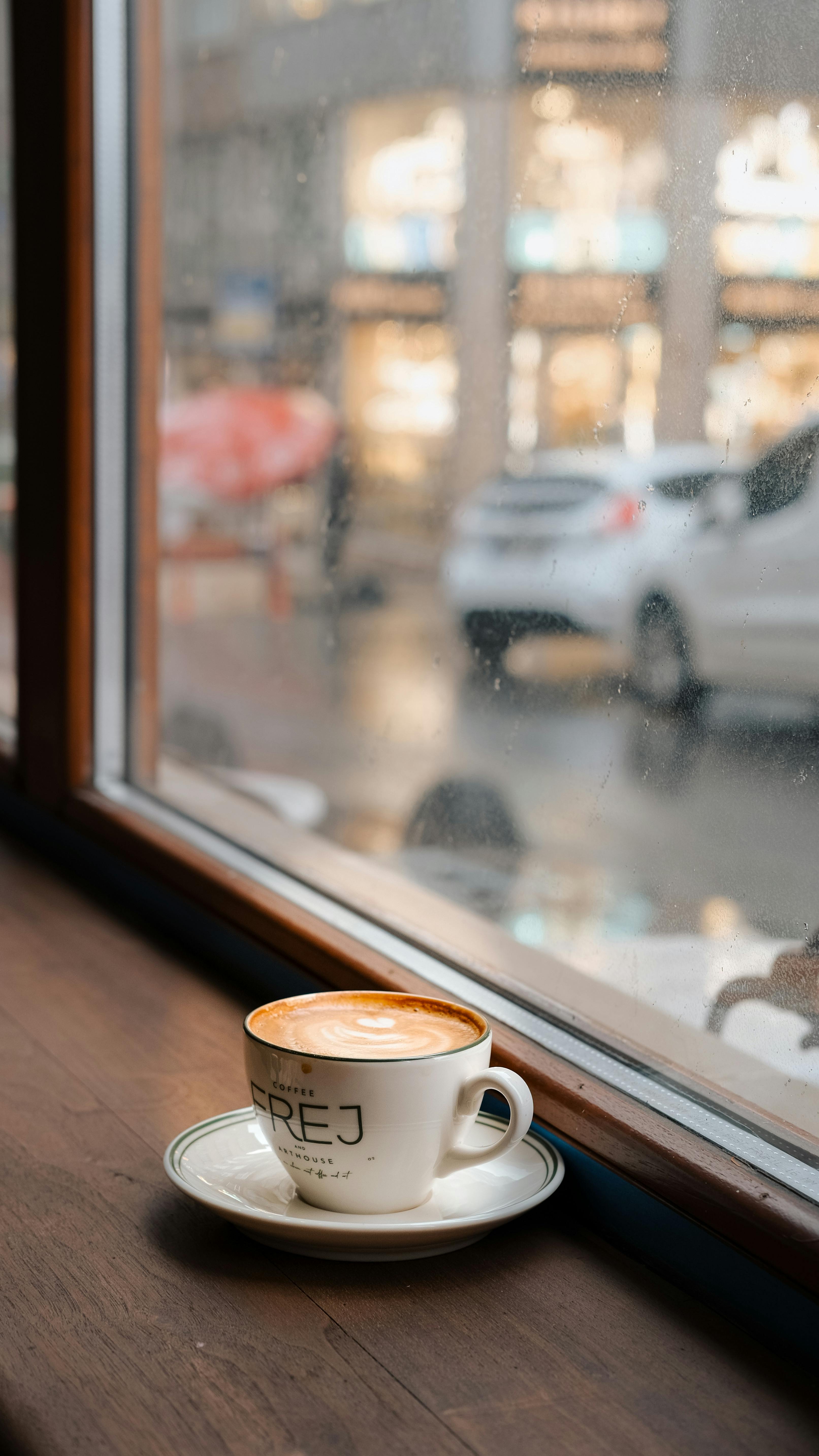 Cozy Coffee Cup by Rainy Window in Café · Free