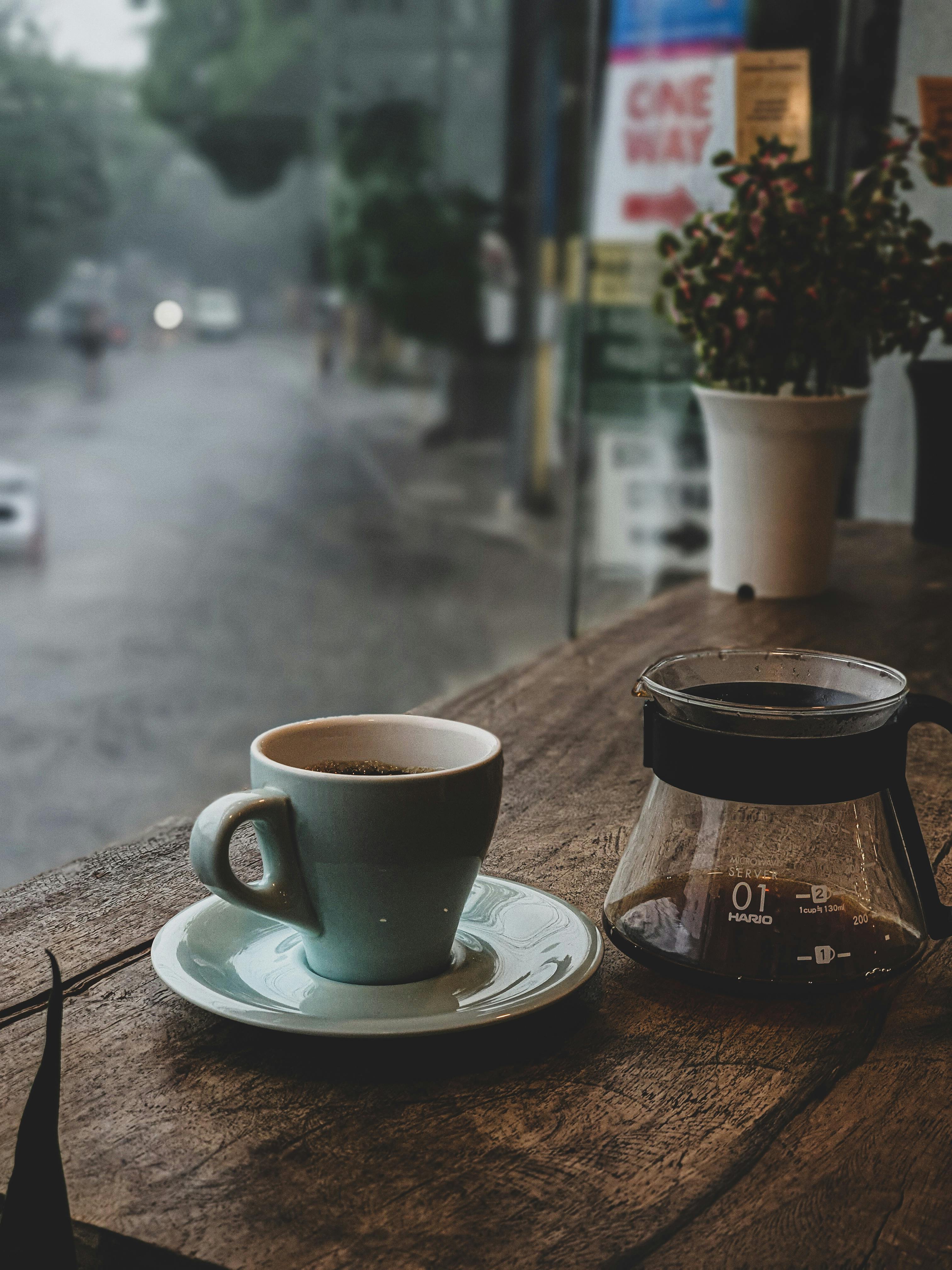 Photo of a Cup of Coffee and a Saucer on a Wooden Surface · Free