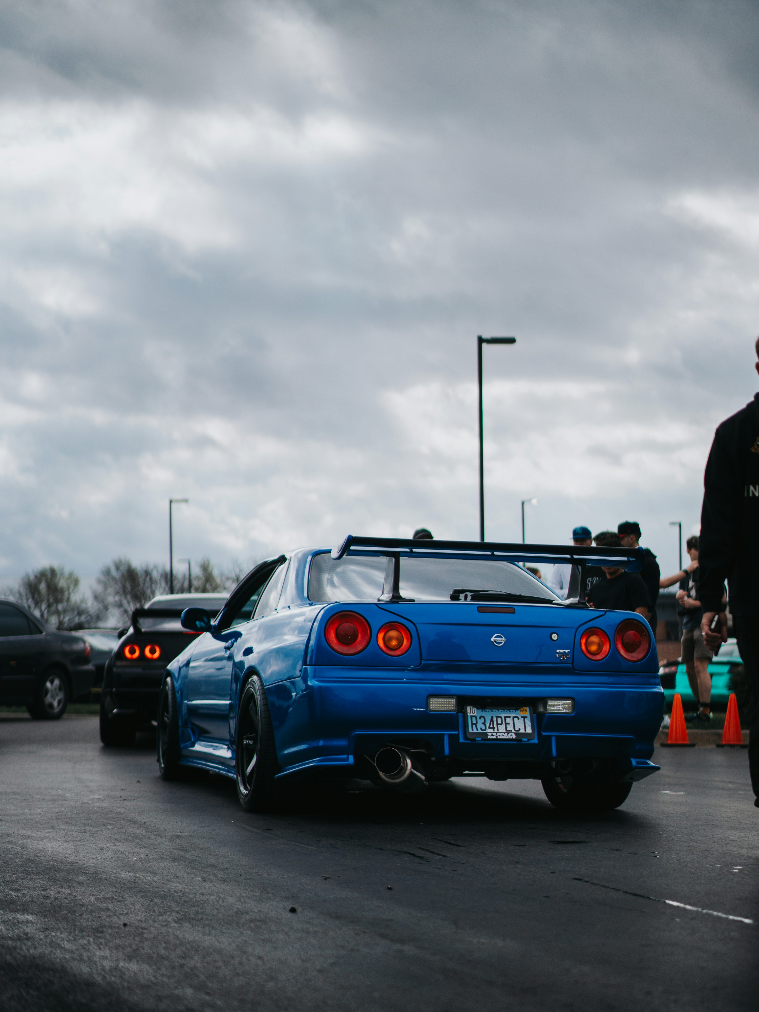 A blue nissan skyline car at an event. photo