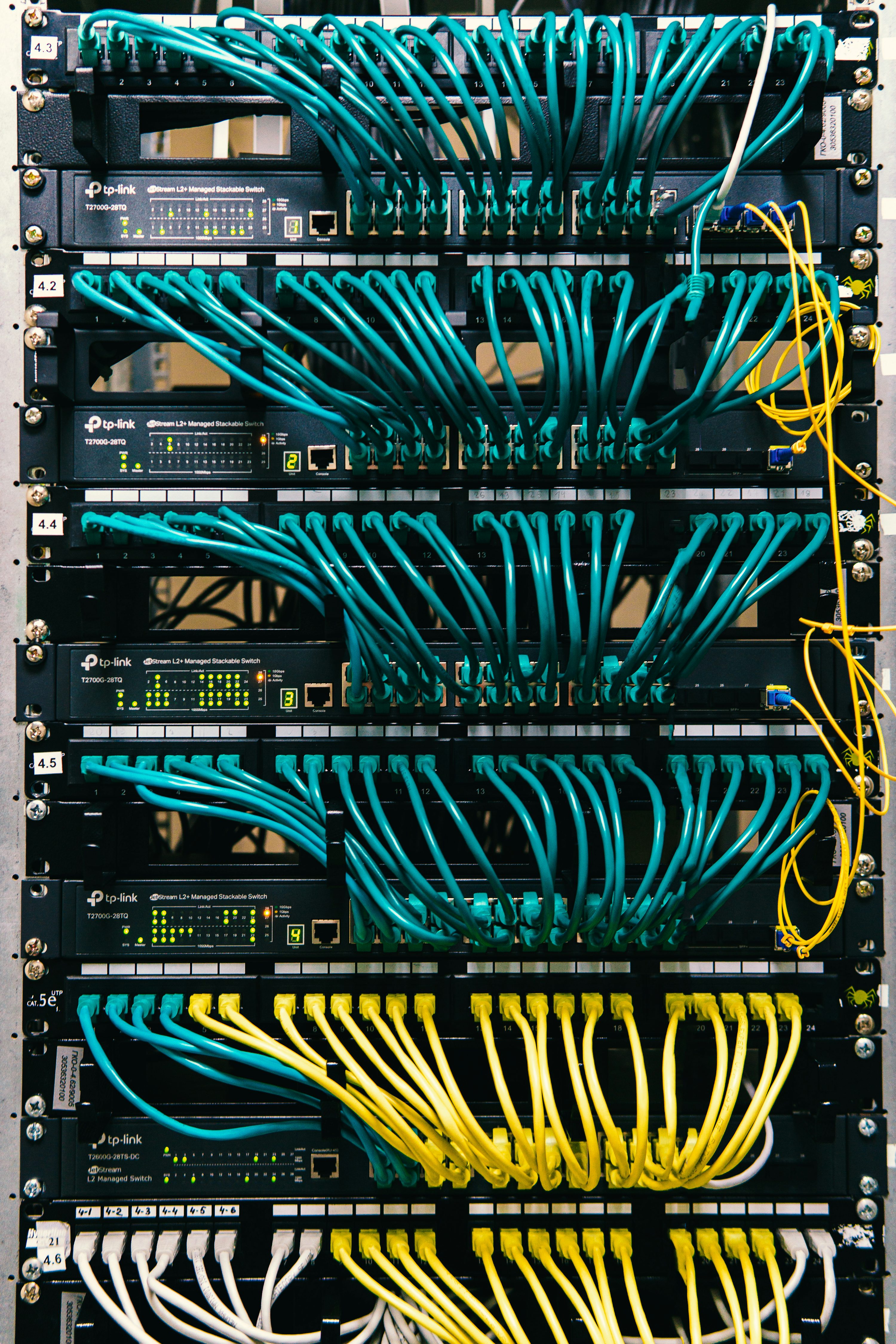 A rack of servers with wires and wires attached to them photo