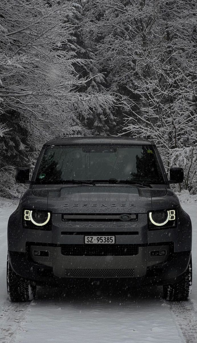 Black Land Rover Defender in the snow