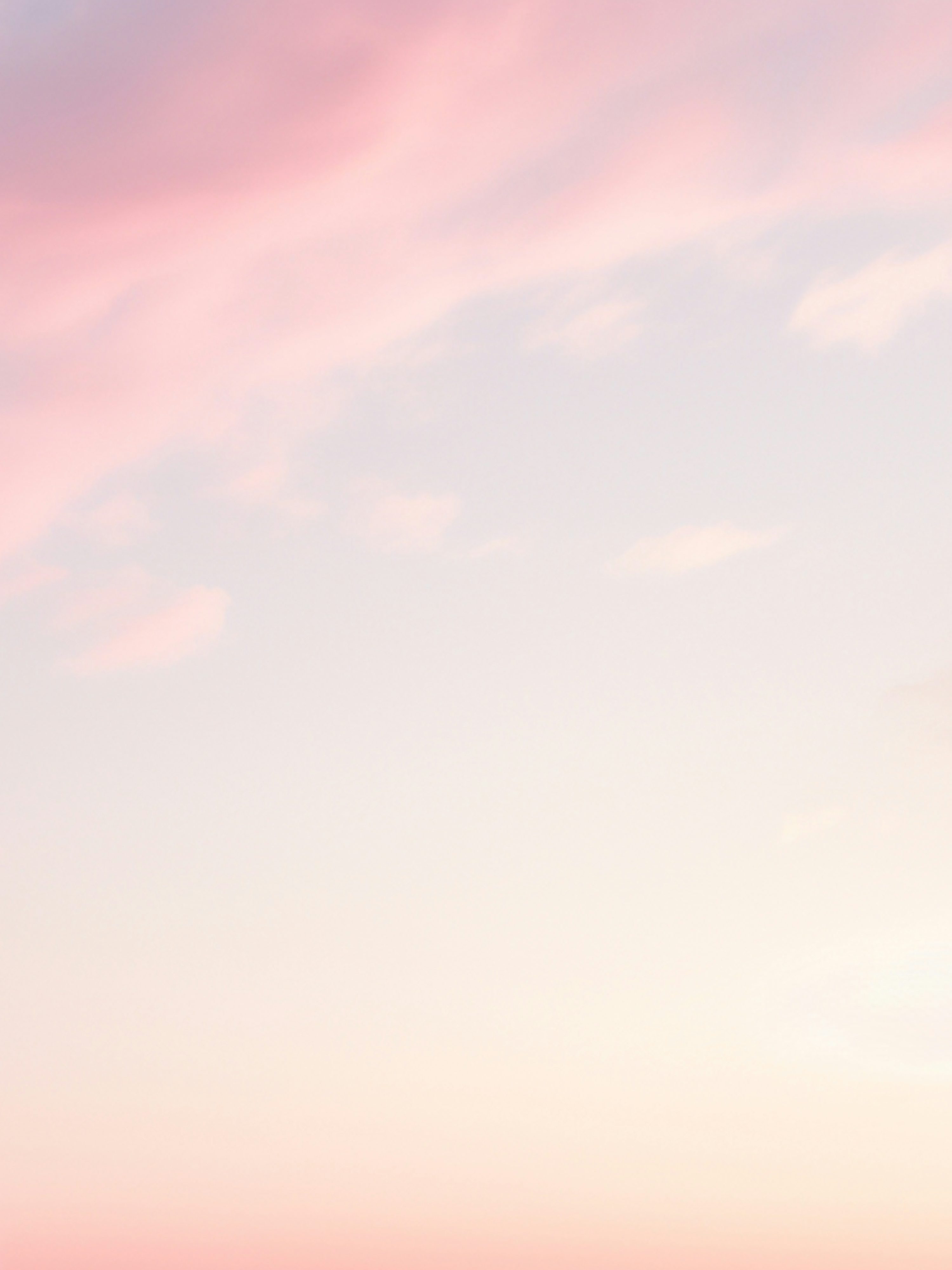 A couple of people standing on top of a sandy beach photo