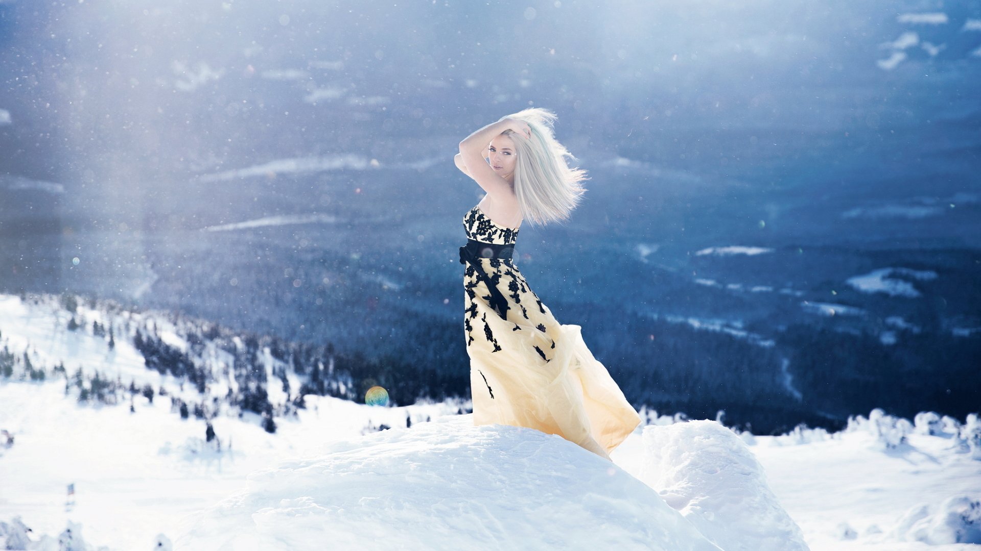 Winter Radiance: Blonde Model in Elegant Dress Amid Sunny Snow