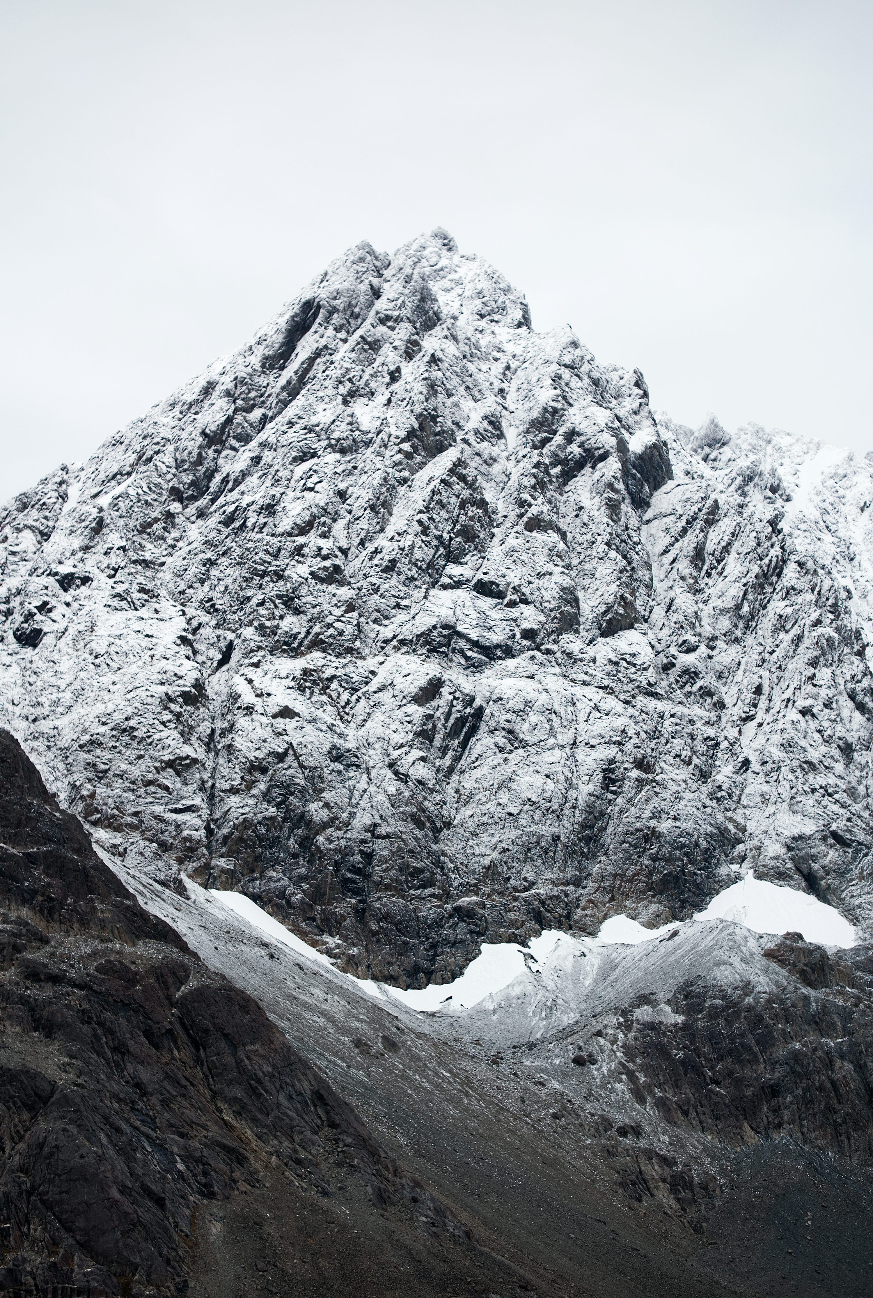 A mountain covered in snow on a cloudy day photo