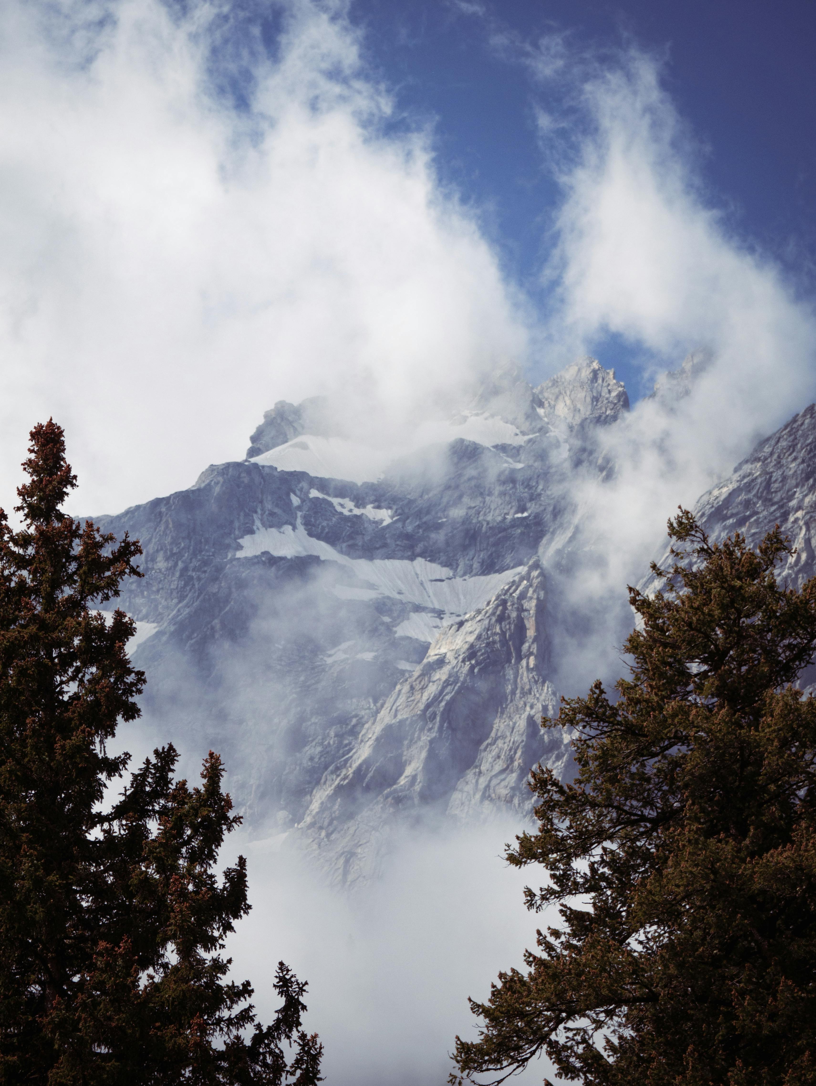 A Cloudy Day at a Snow Capped Mountain · Free