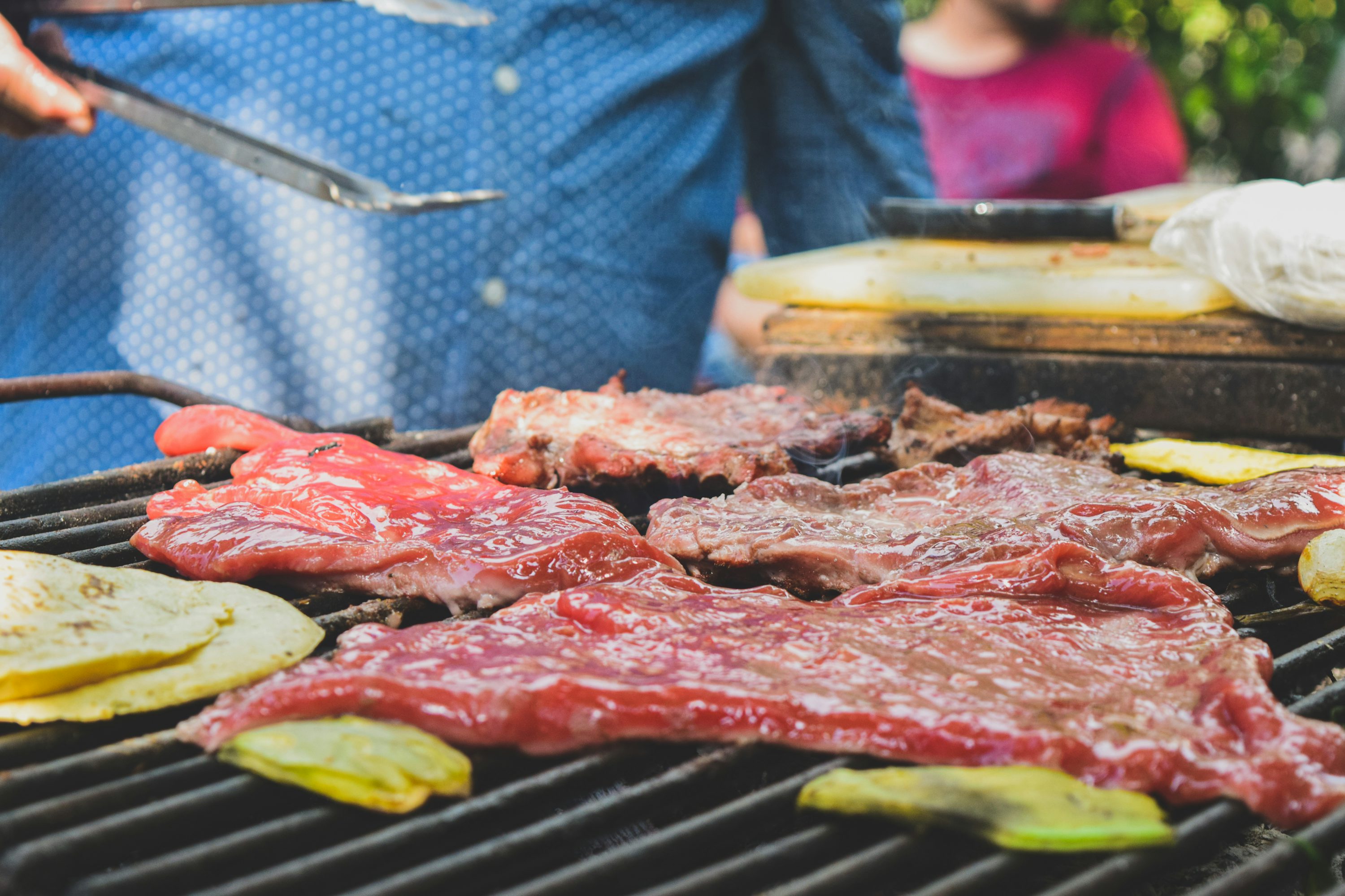 Man in blue dress shirt slicing meat photo