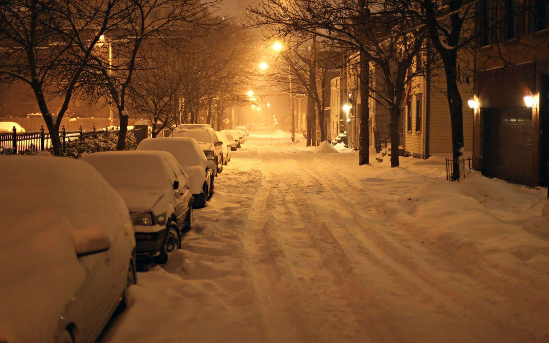 Download A Street With Cars Parked In The Snow Wallpaper