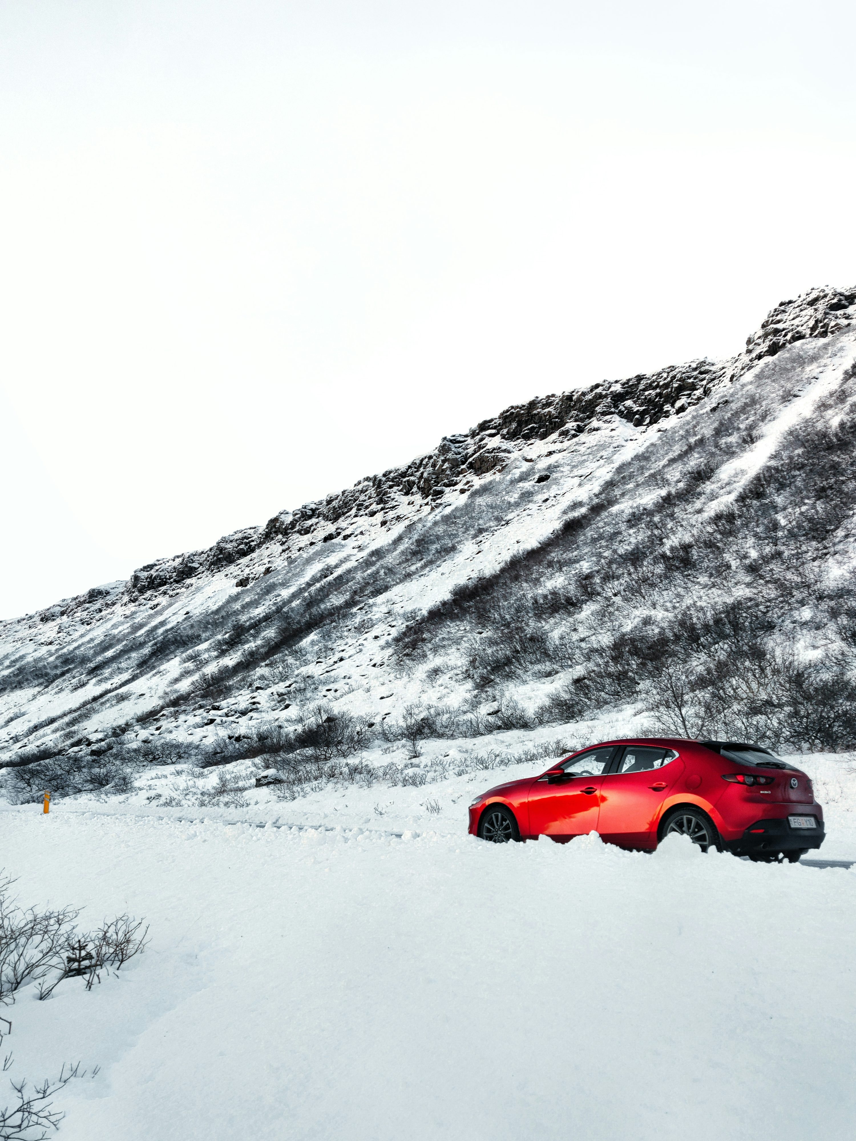 A red car is parked in the snow photo