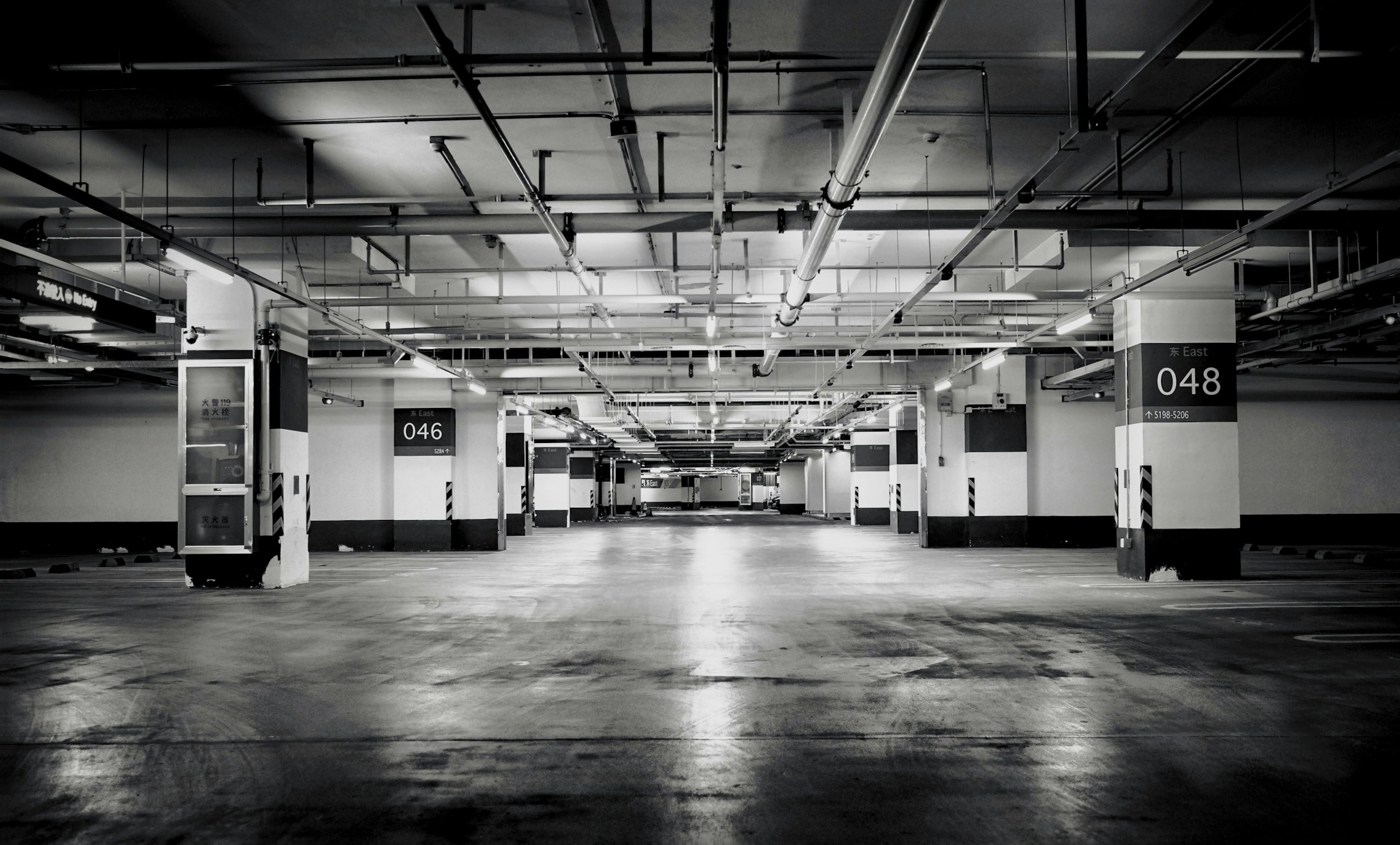 A black and white photo of an empty parking garage photo