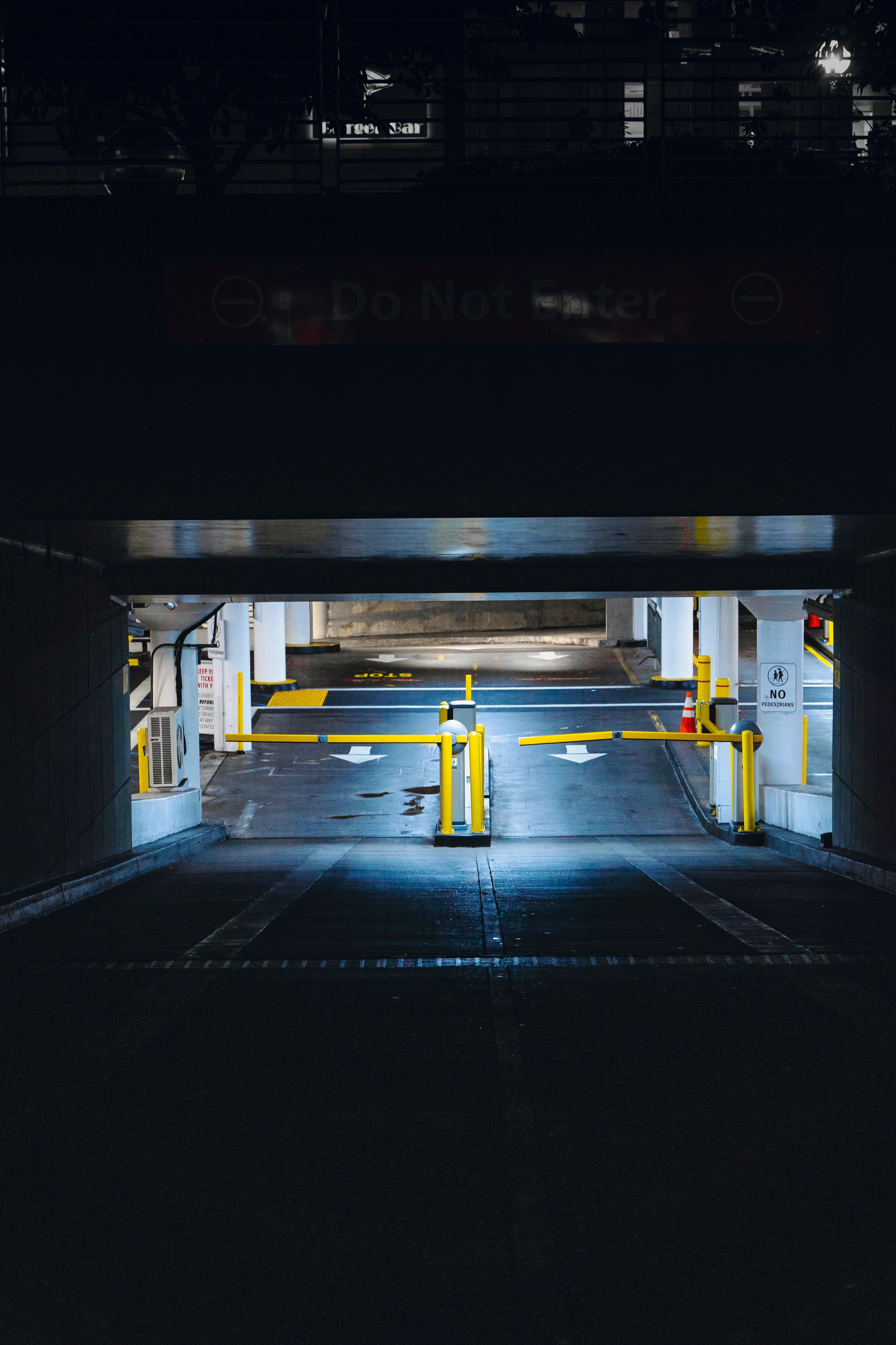 An empty parking garage with yellow barriers photo