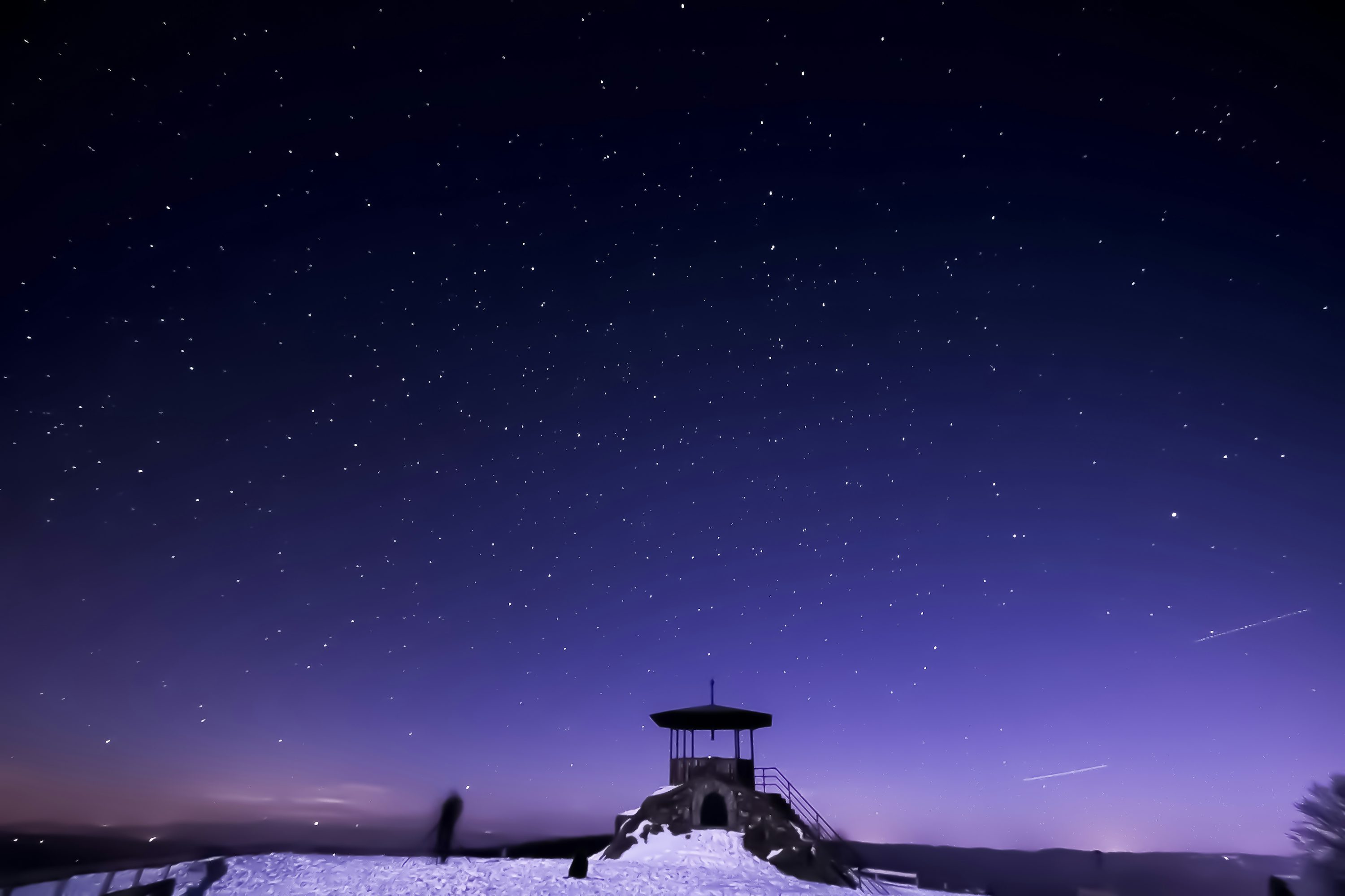 Black concrete gazebo covered in snow photo
