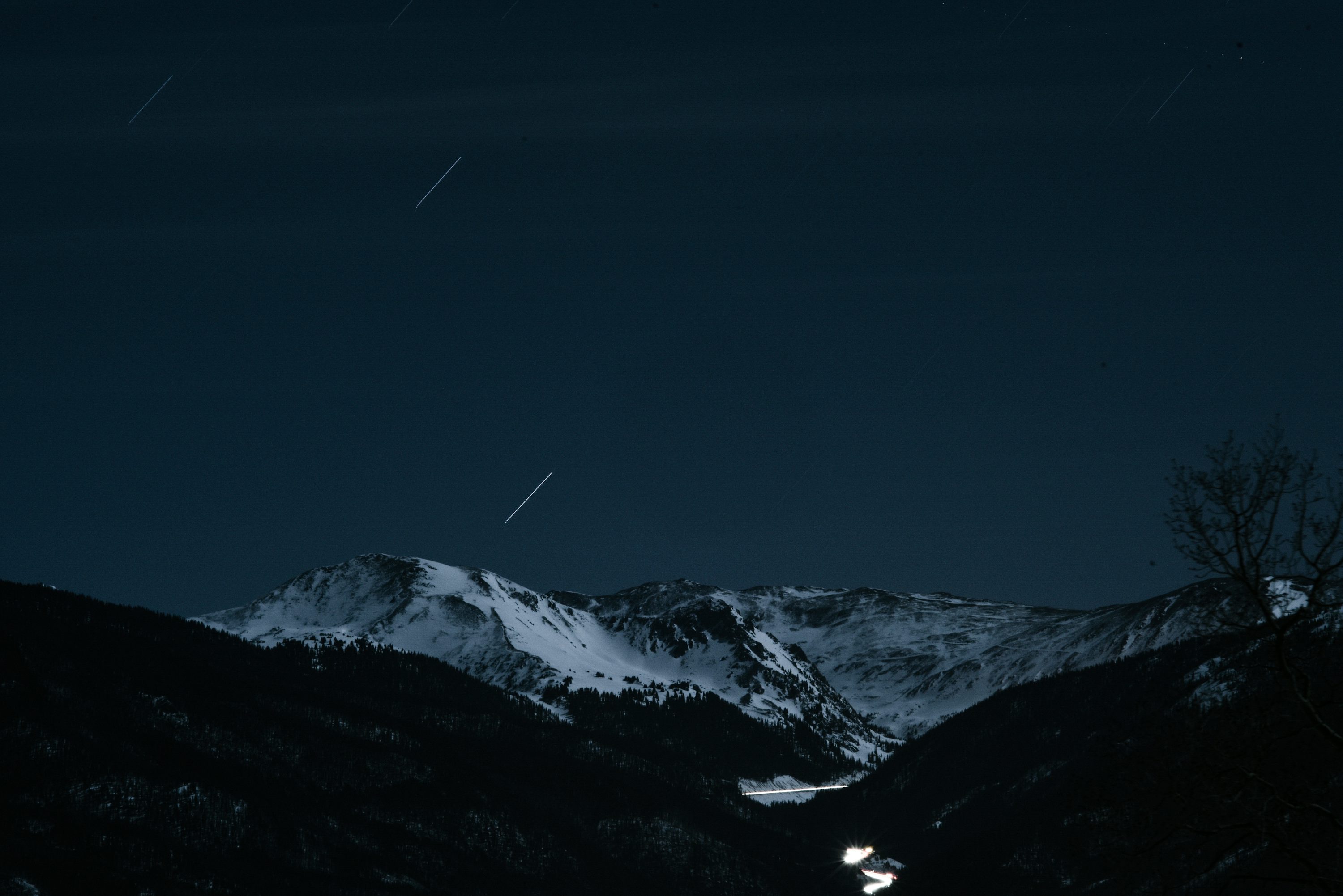 The night sky over a snowy mountain range photo