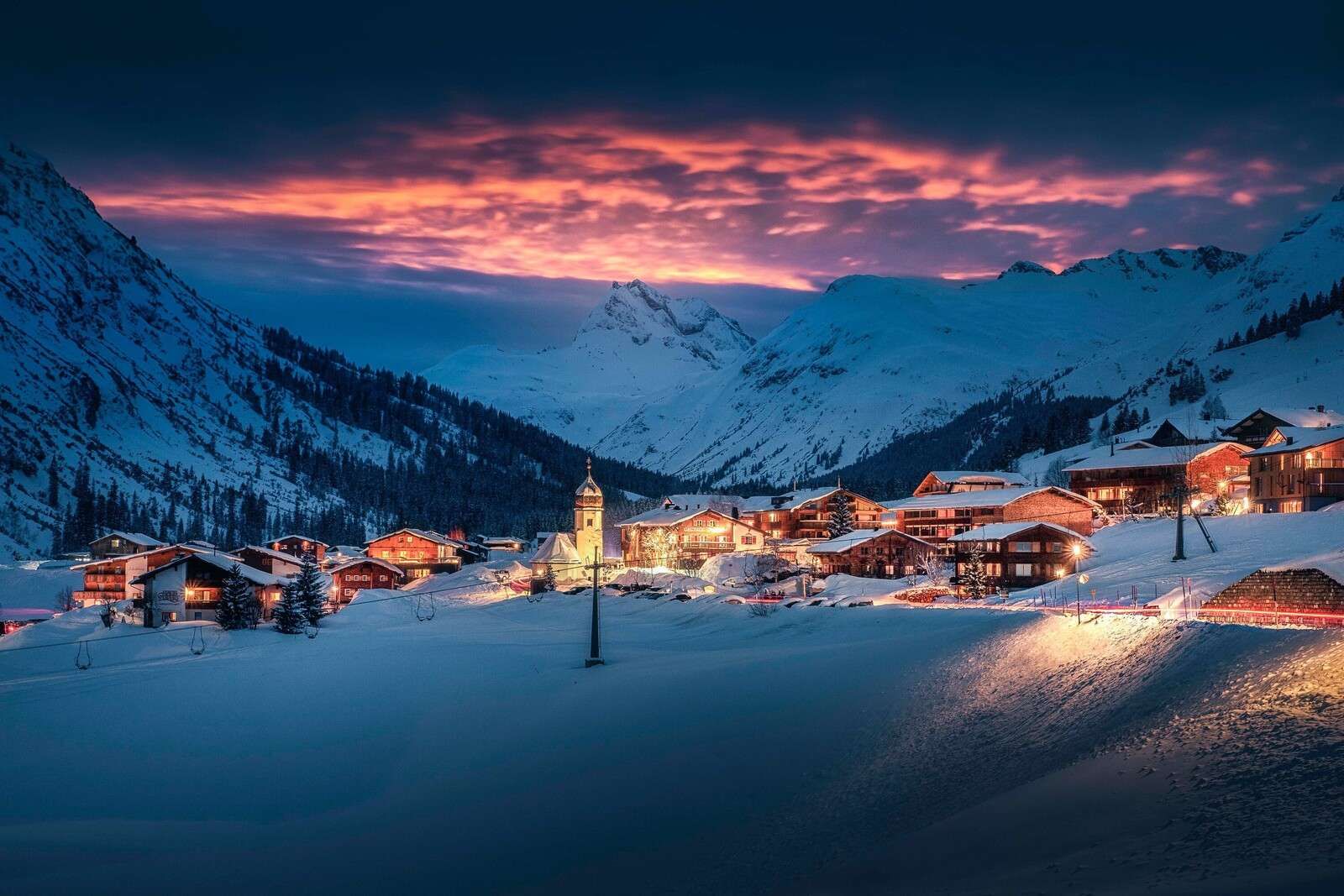 Wall Mural light over mountain village in the snow