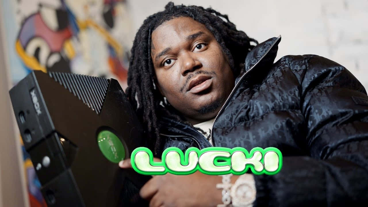 Download Rapper Lucki Holding Game Console Wallpaper