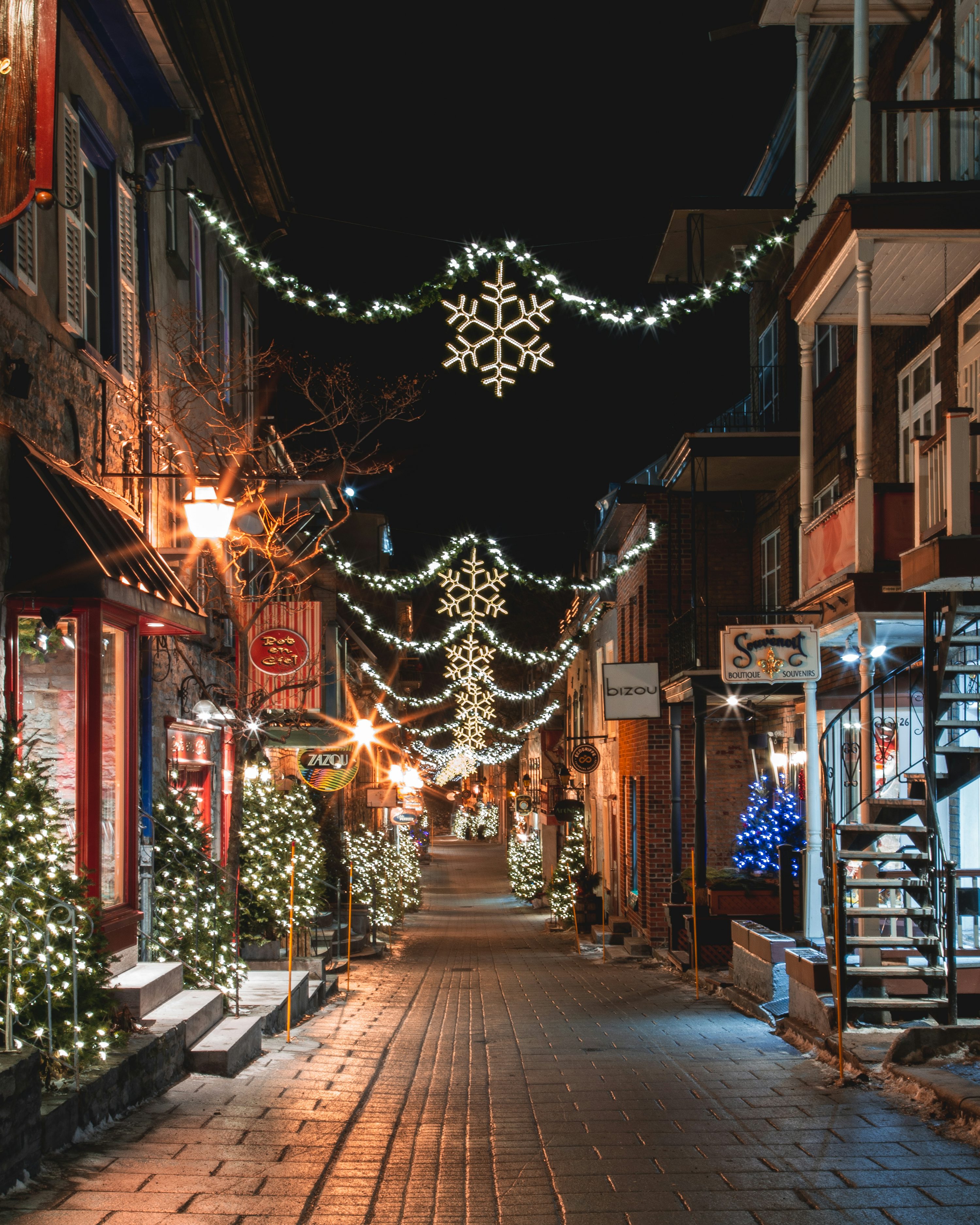 A city street is decorated with christmas lights photo
