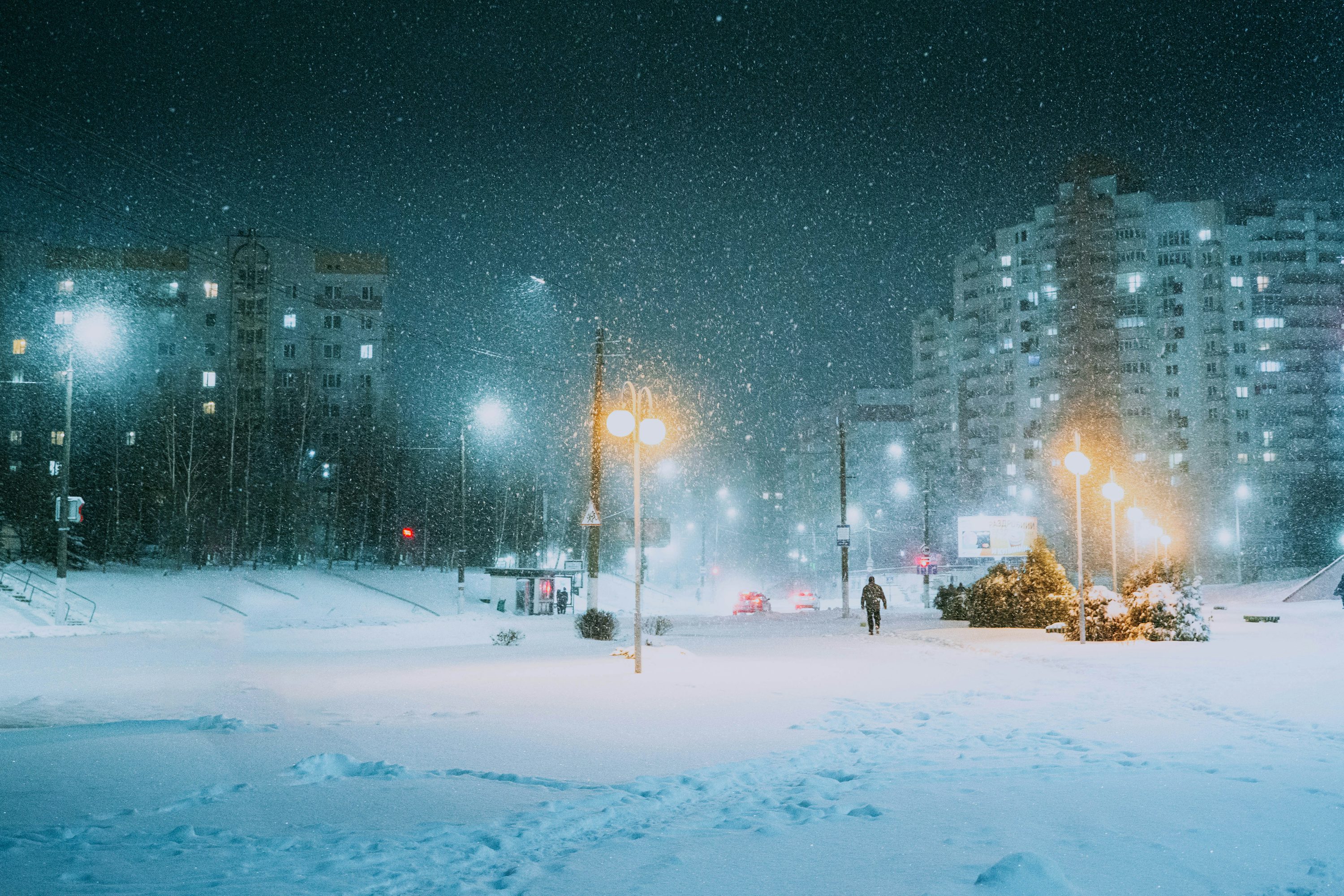 A snowy night in a big city with a lot of lights photo