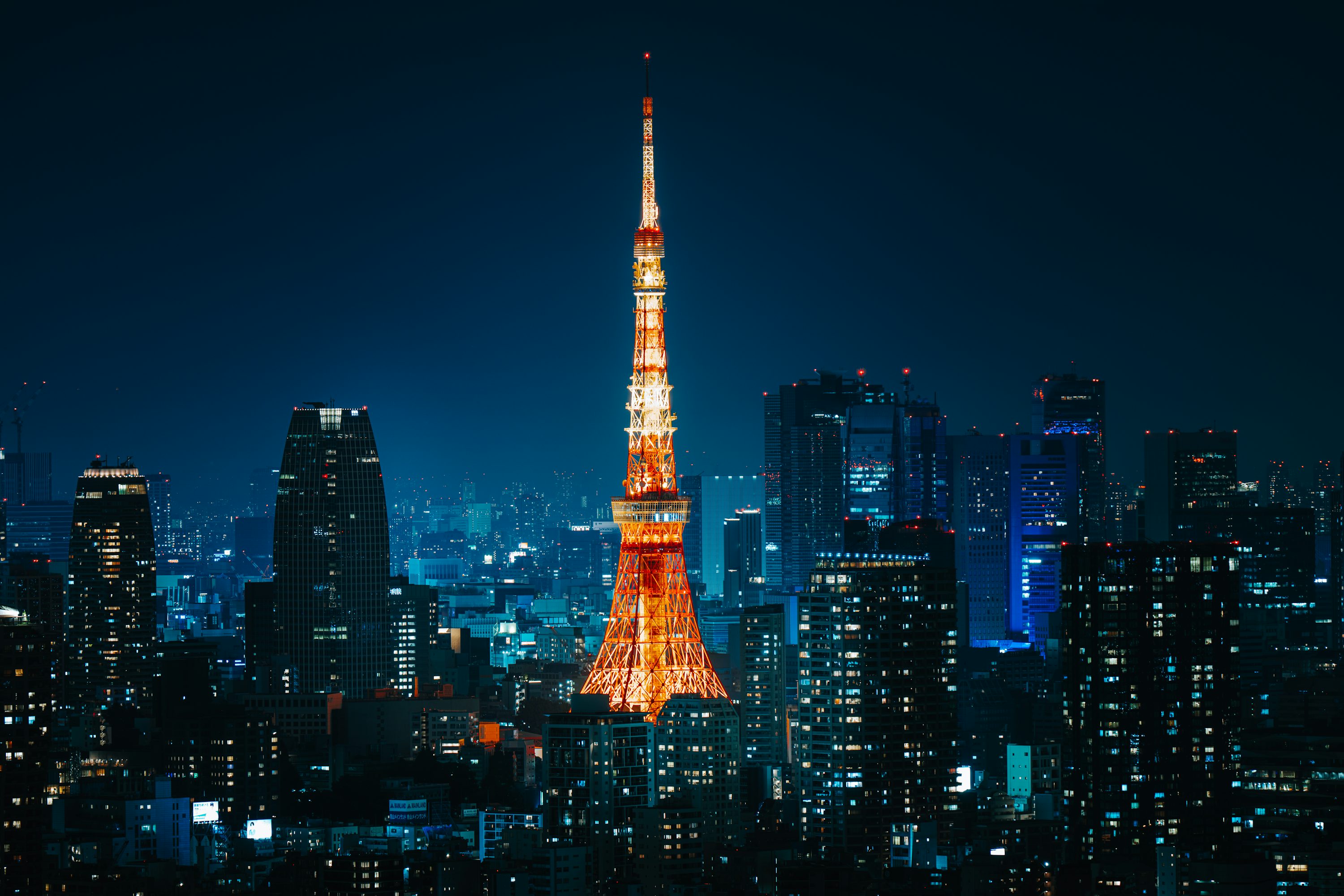 The tokyo tower is lit up at night photo