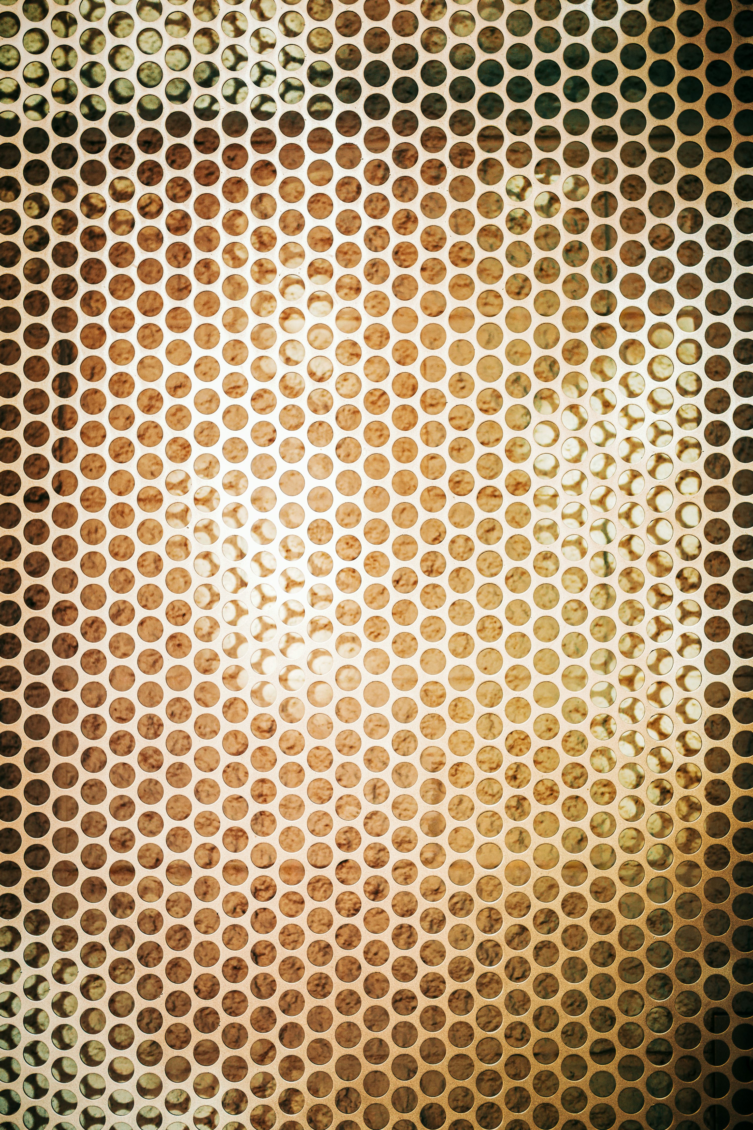 Perforated metal surface with warm lighting photo