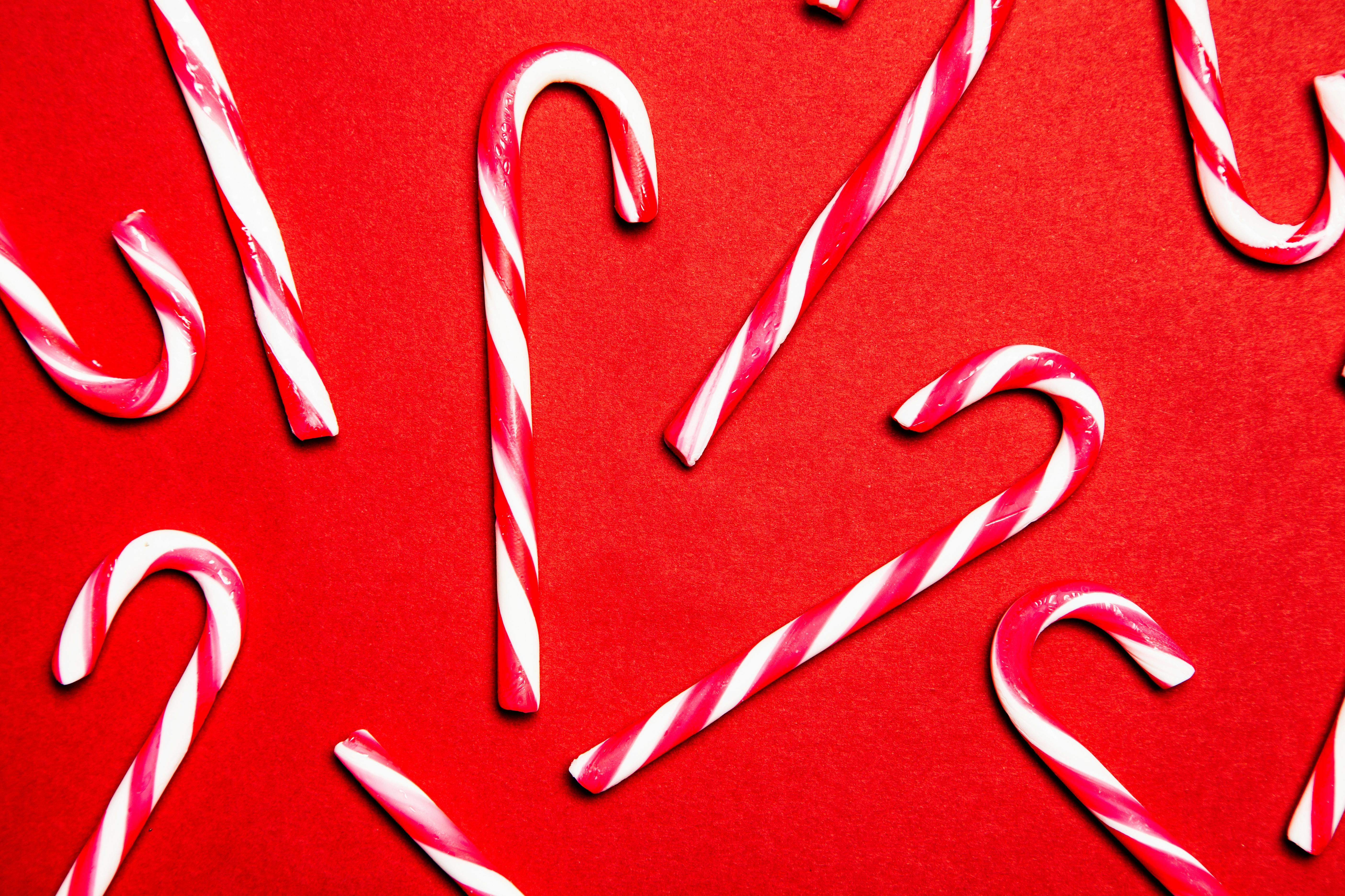 Red and White Candy Canes on Red Background · Free