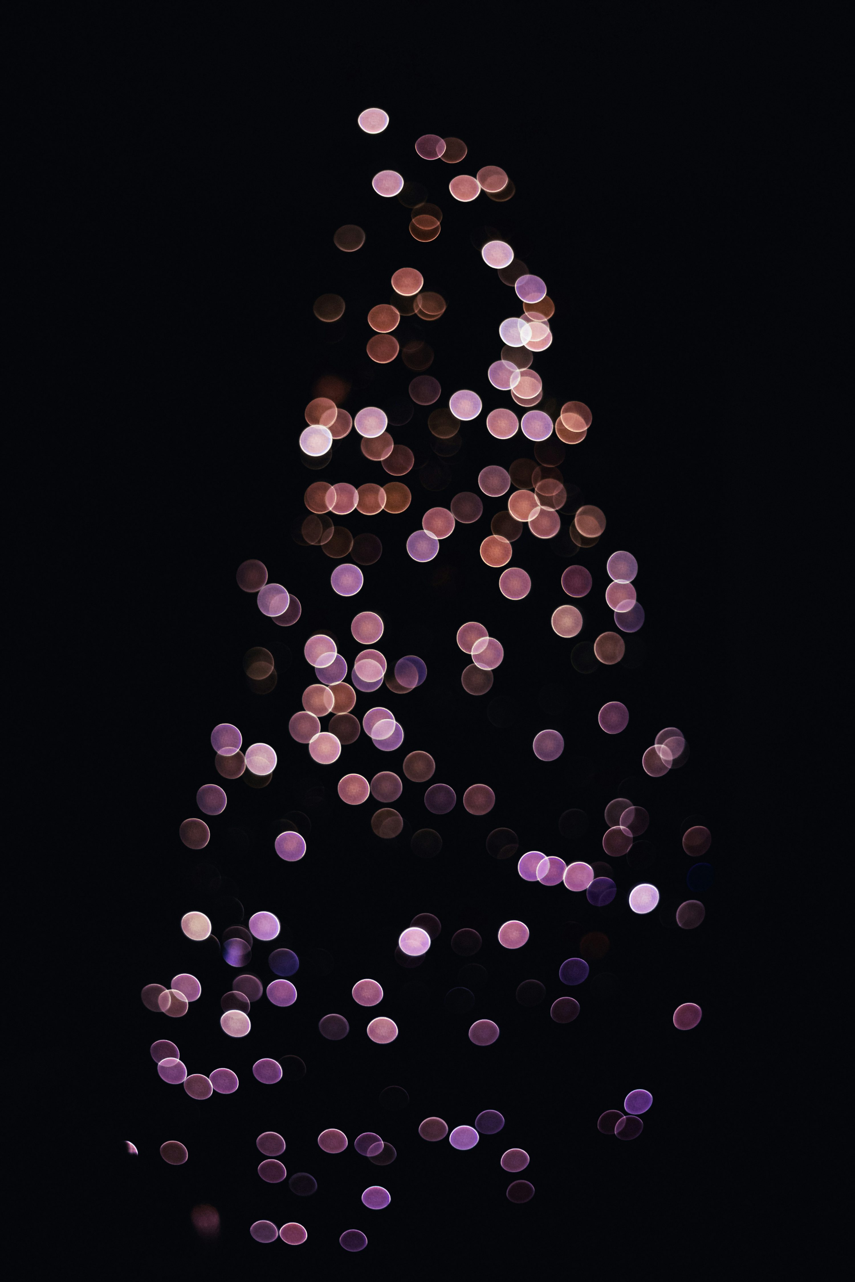 A blurry photo of a christmas tree in the dark photo