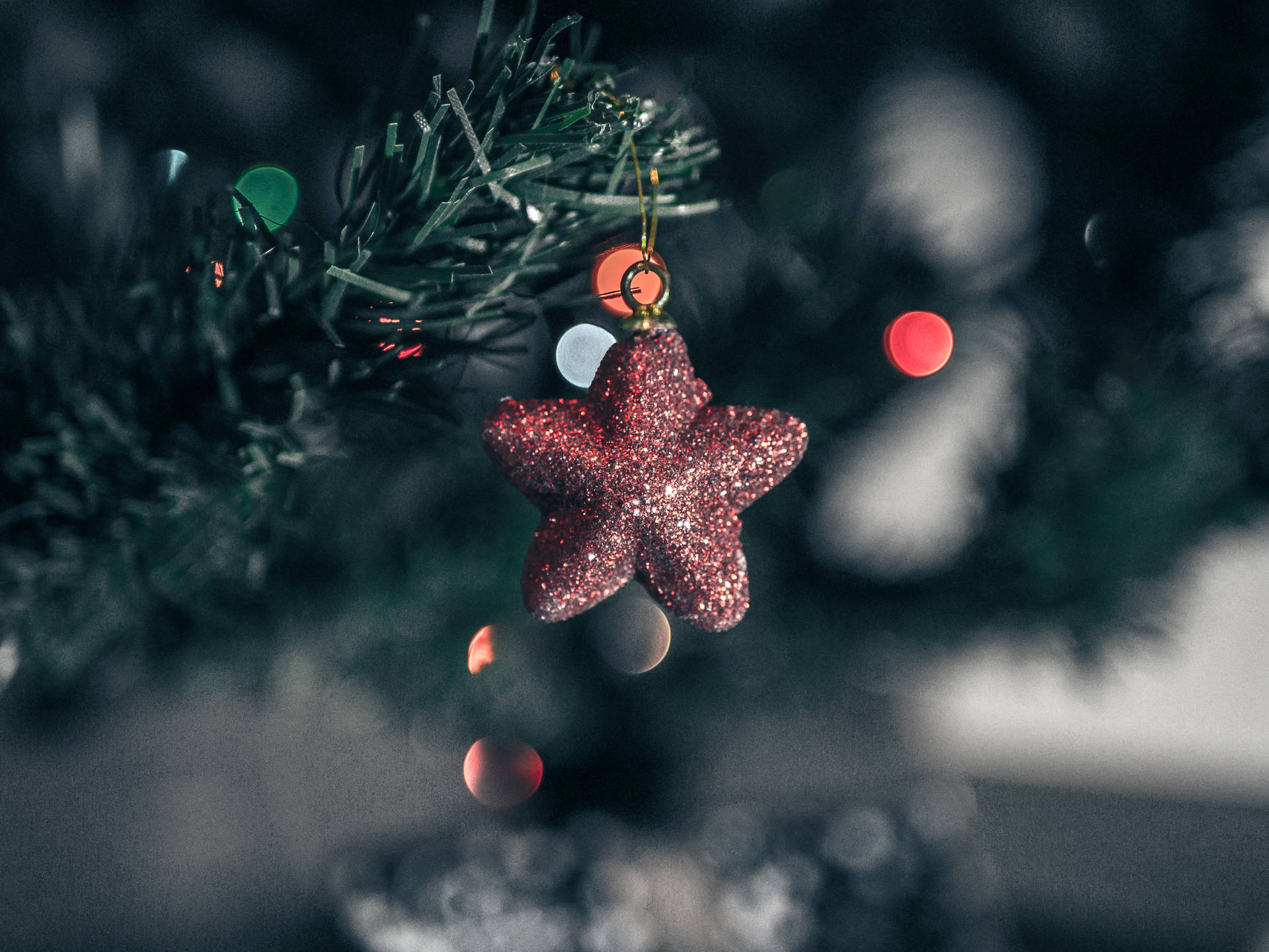 Download A Star Lit Christmas Tree Shines Brightly Against A Dark Night. Wallpaper