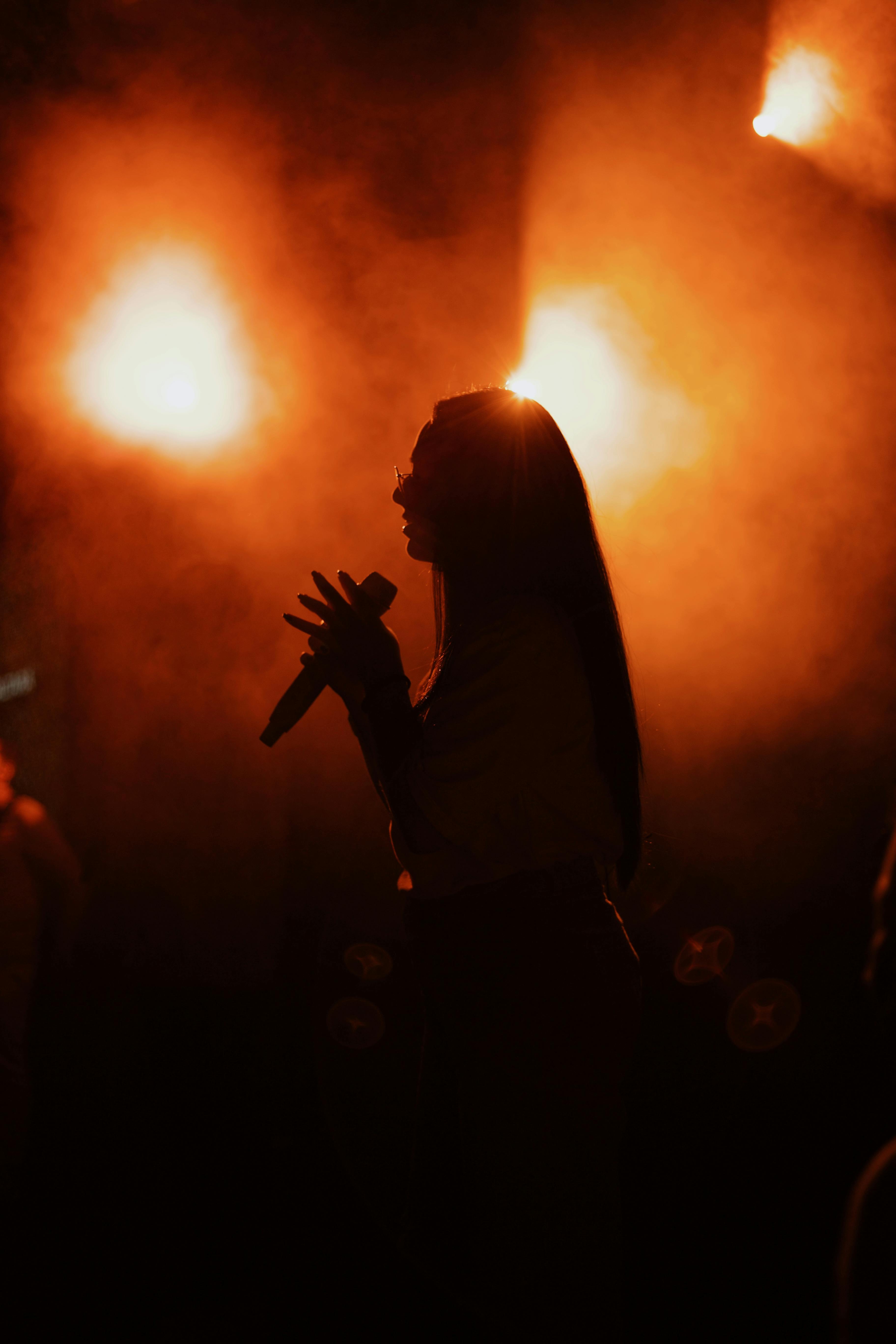A Silhouette of a Woman Singing · Free