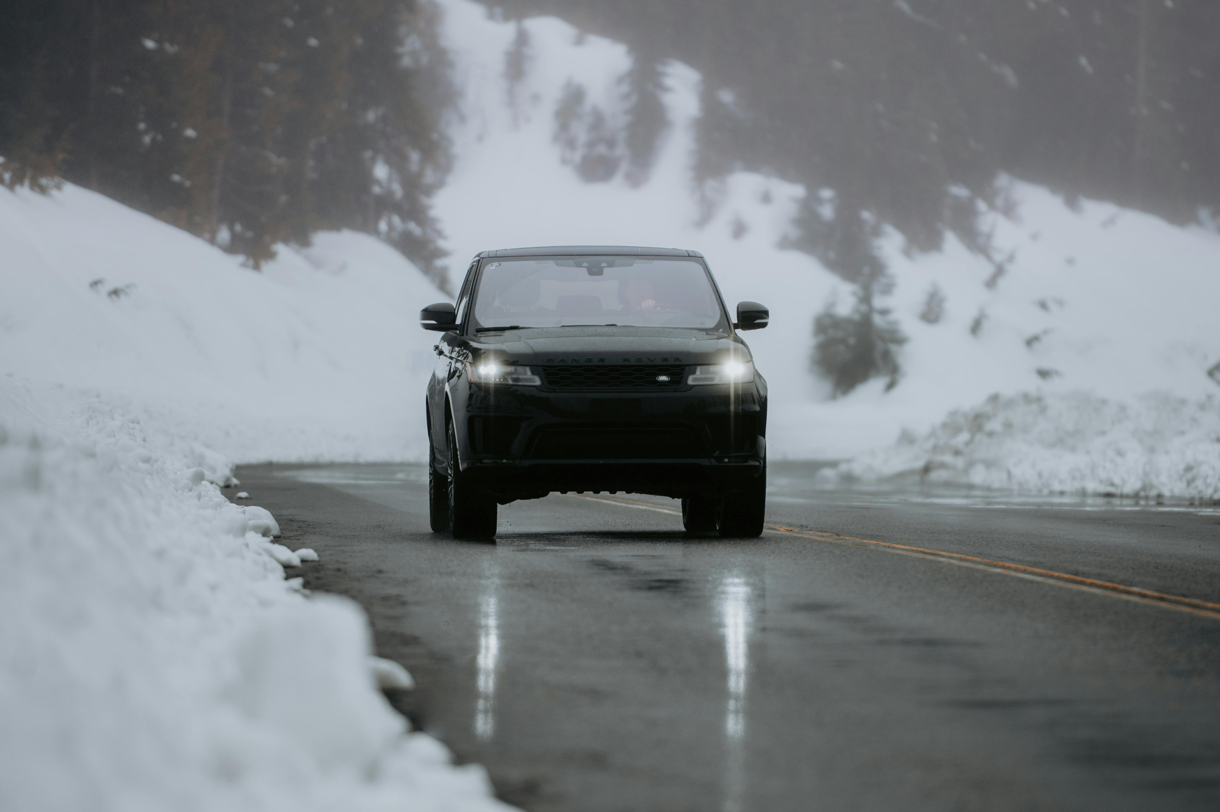 A Black Range Rover on an Asphalt Road in Winter · Free