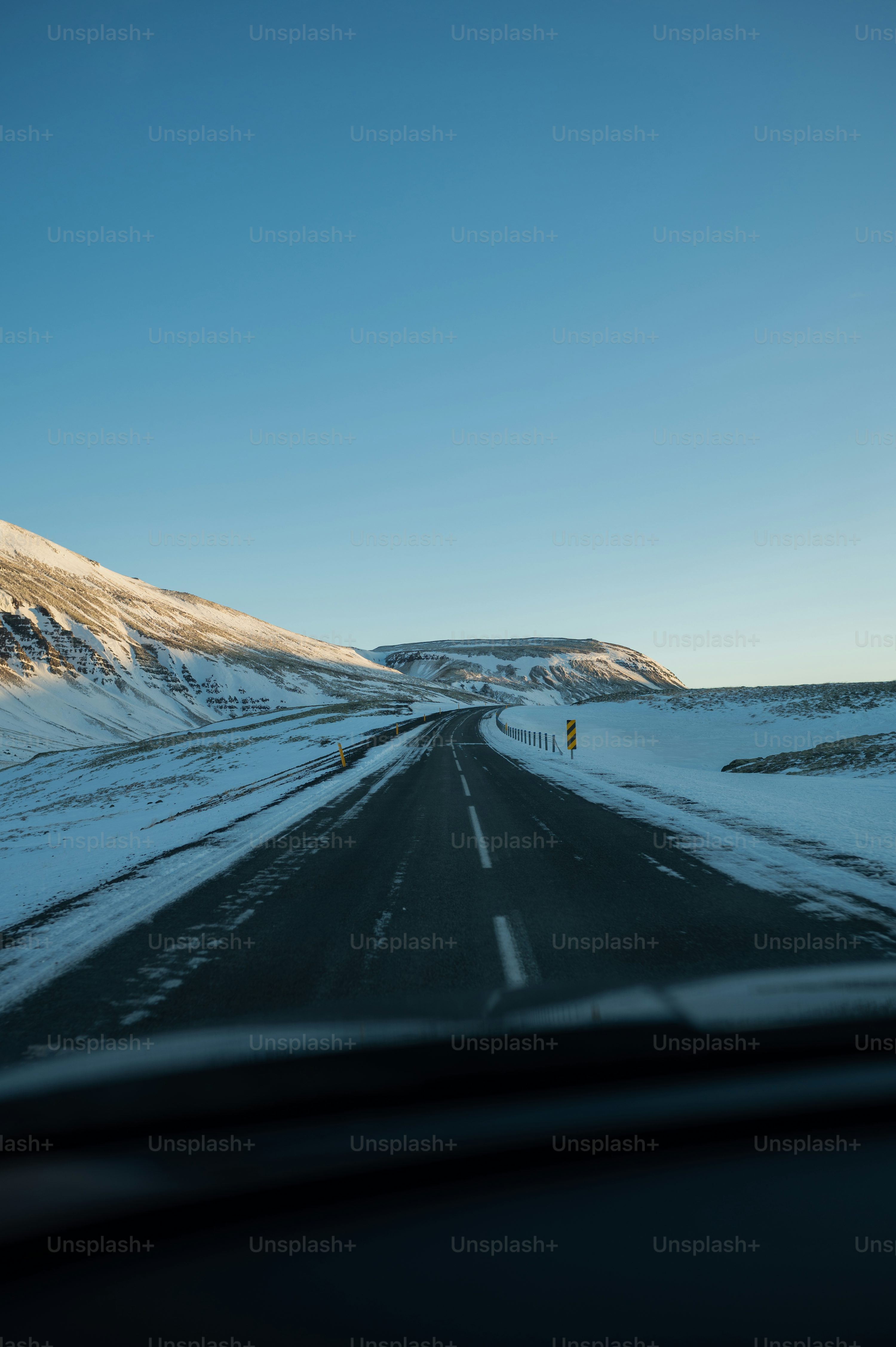 A car driving down a snow covered road photo
