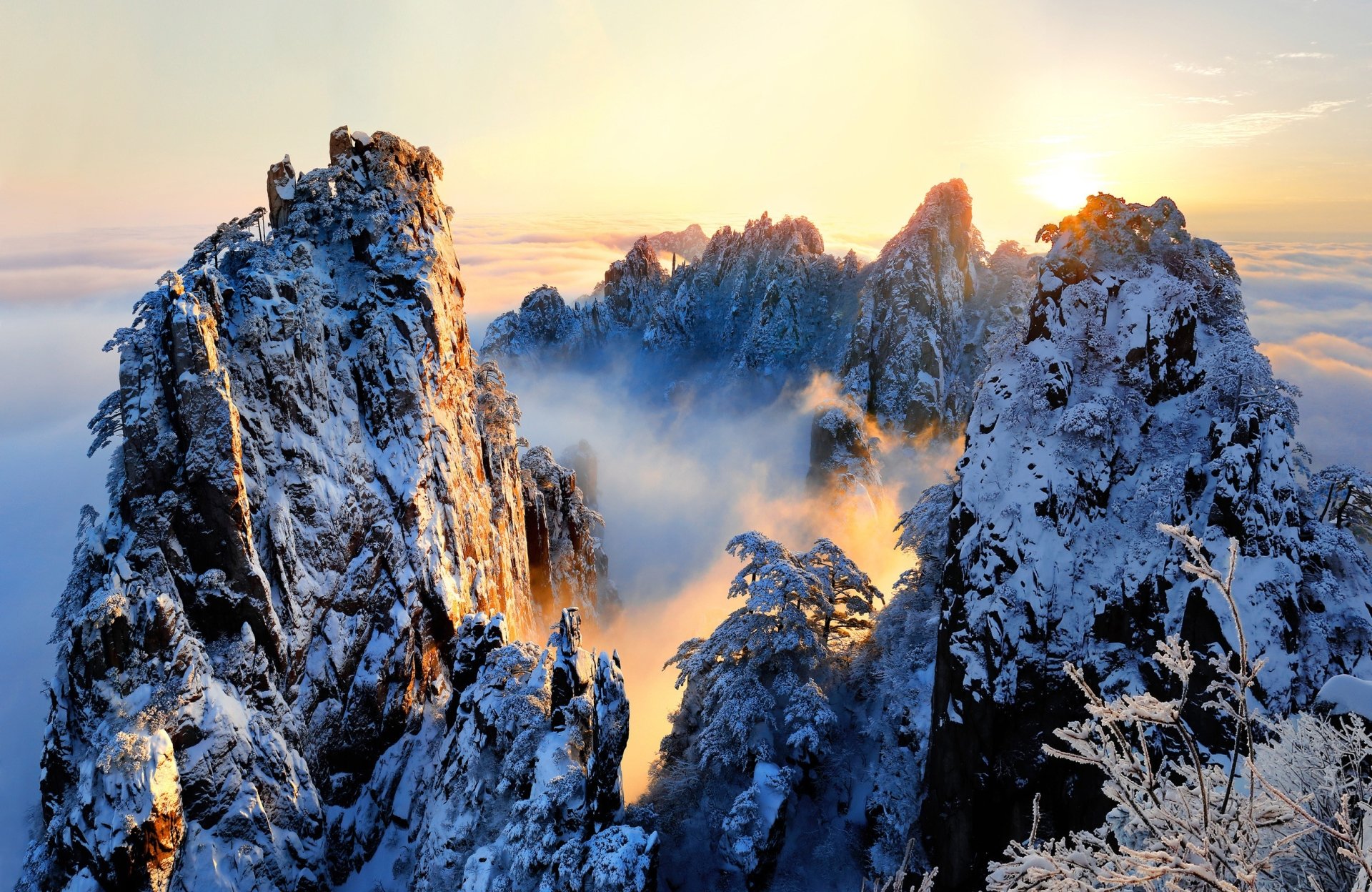 Winter Sunrise Over Misty Mountain Peaks