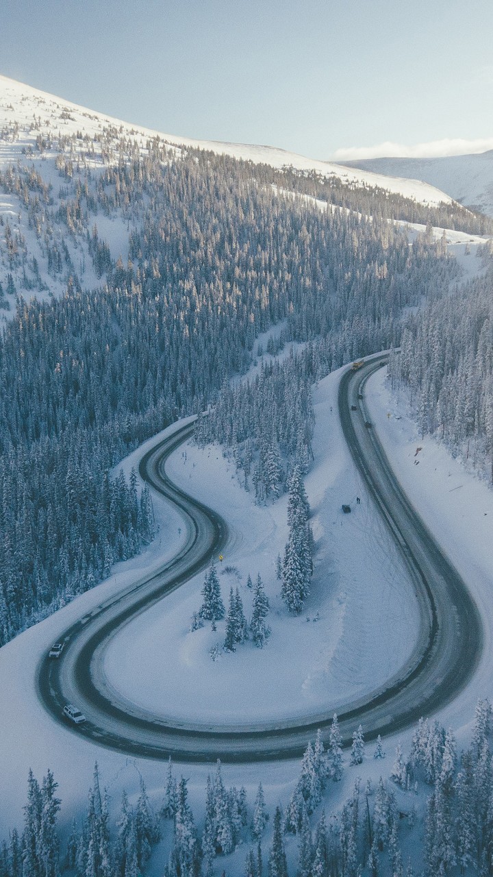 Aerial View Of Mountain Road And Snow Covered Mountain With Trees 4K HD Winter Wallpaper