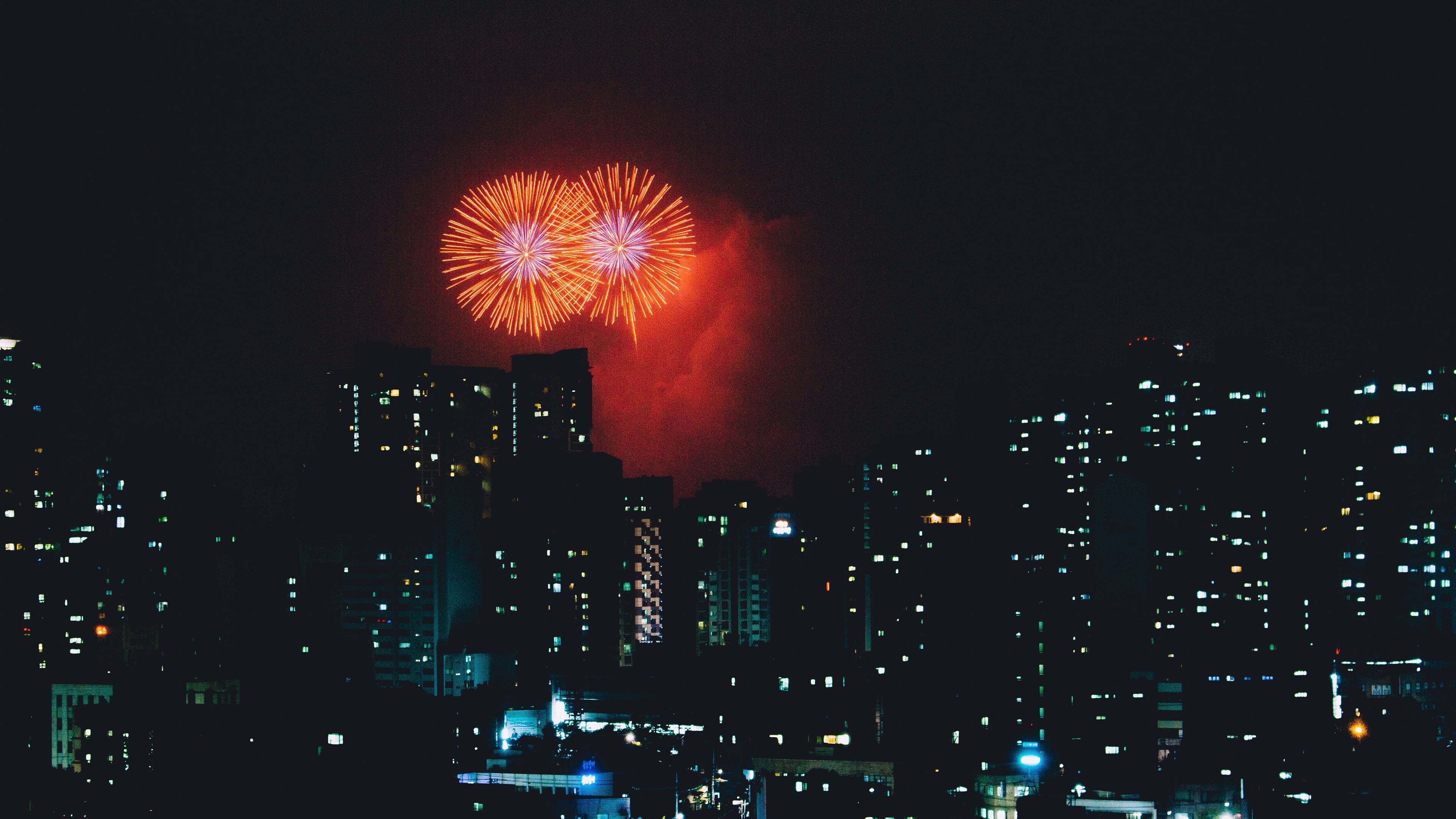 Fireworks over buildings Wallpaper 4k for Desktop