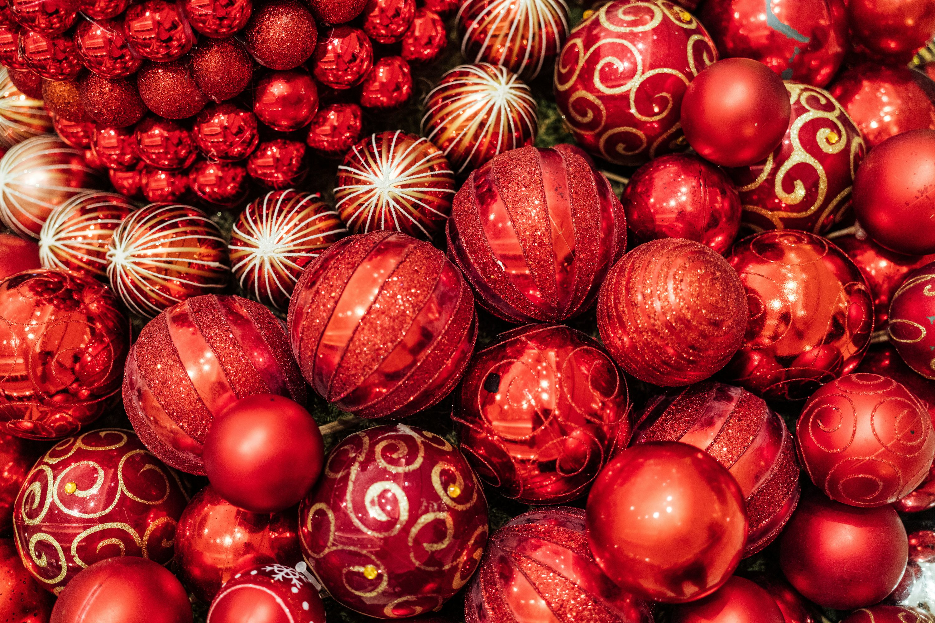 A pile of red christmas ornaments sitting next to each other photo